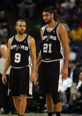 OAKLAND, CA - DECEMBER 16:  Tim Duncan #21 and Tony Parker #9 of the San Antonio Spurs stand on the court during their game against the Golden State Warriors at Oracle Arena on December 16, 2009 in Oakland, California. NOTE TO USER: User expressly acknowl