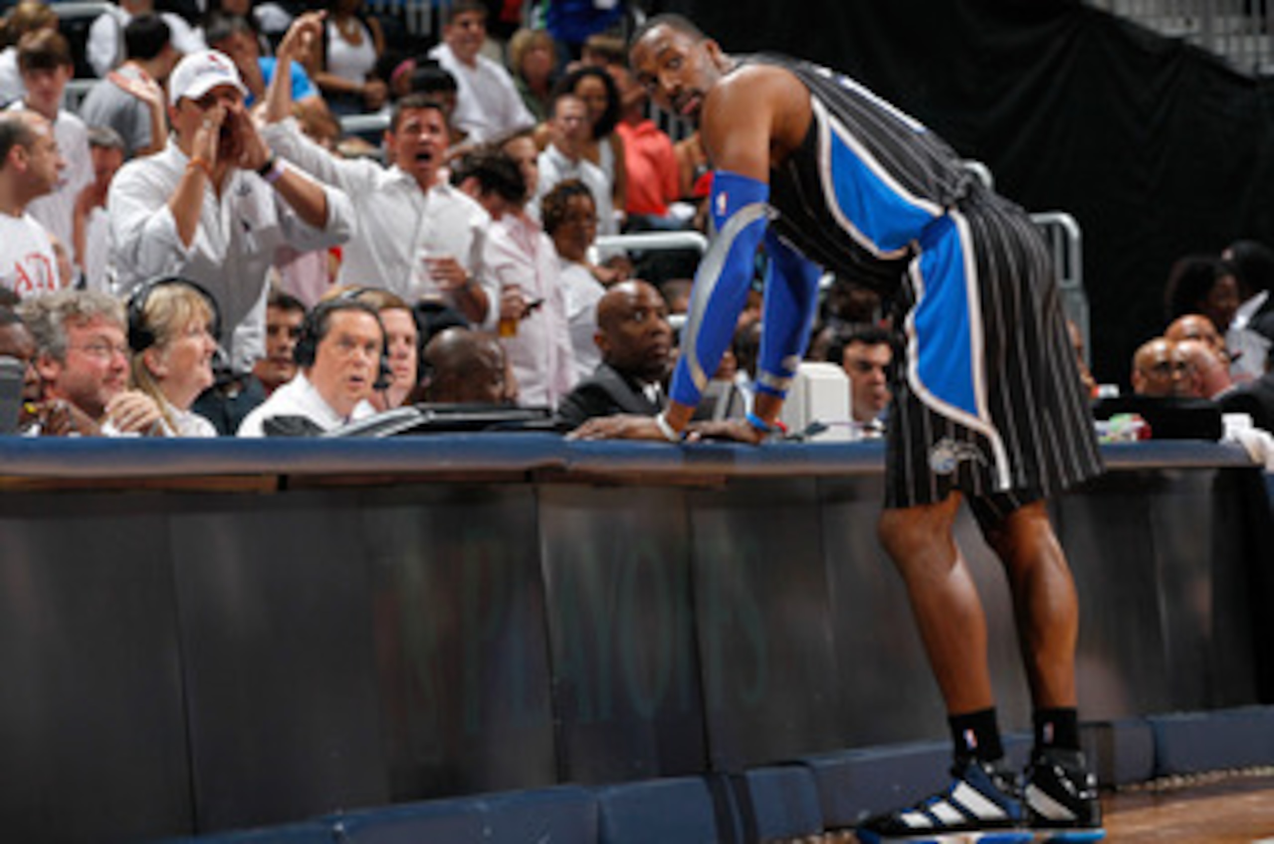 ATLANTA, GA - APRIL 28:  Dwight Howard #12 of the Orlando Magic stands at the scorer's table after being earning a technical foul against Zaza Pachulia #27 of the Atlanta Hawks during Game Six of the Eastern Conference Quarterfinals in the 2011 NBA Playof