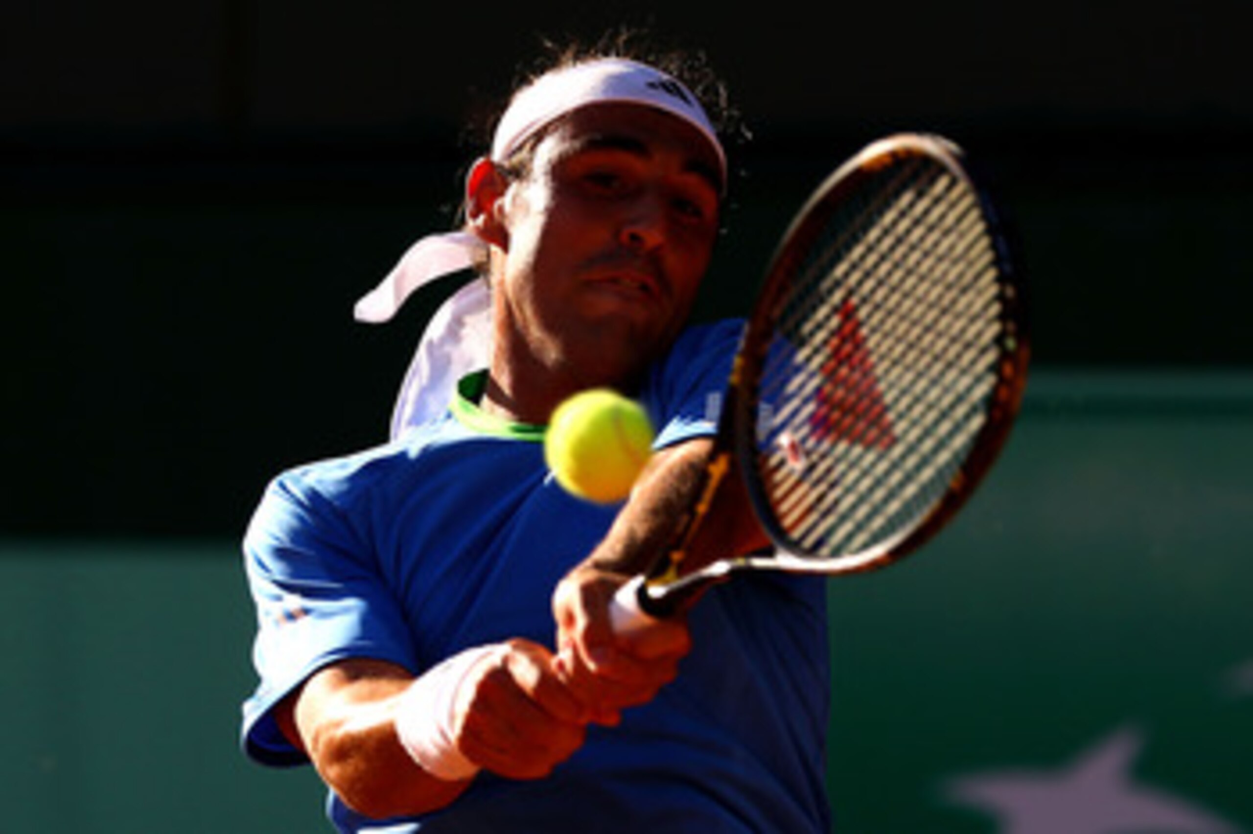 PARIS, FRANCE - MAY 23:  Marcos Baghdatis of Cyprus plays a backhand during the men's singles first round match between Marcos Baghdatis of Cyprus and Frederico Gil of Portugal on day two of the French Open at Roland Garros on May 23, 2011 in Paris, Franc
