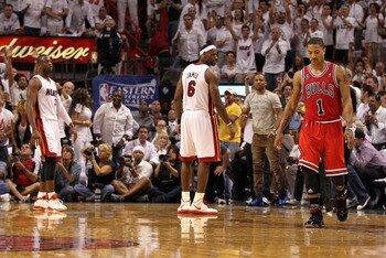MIAMI, FL - MAY 24: Derrick Rose #1 of the Chicago Bulls walks up court as LeBron James #6 (C) and Dwyane Wade #3 of the Miami Heat look on in Game Four of the Eastern Conference Finals during the 2011 NBA Playoffs on May 24, 2011 at American Airlines Are
