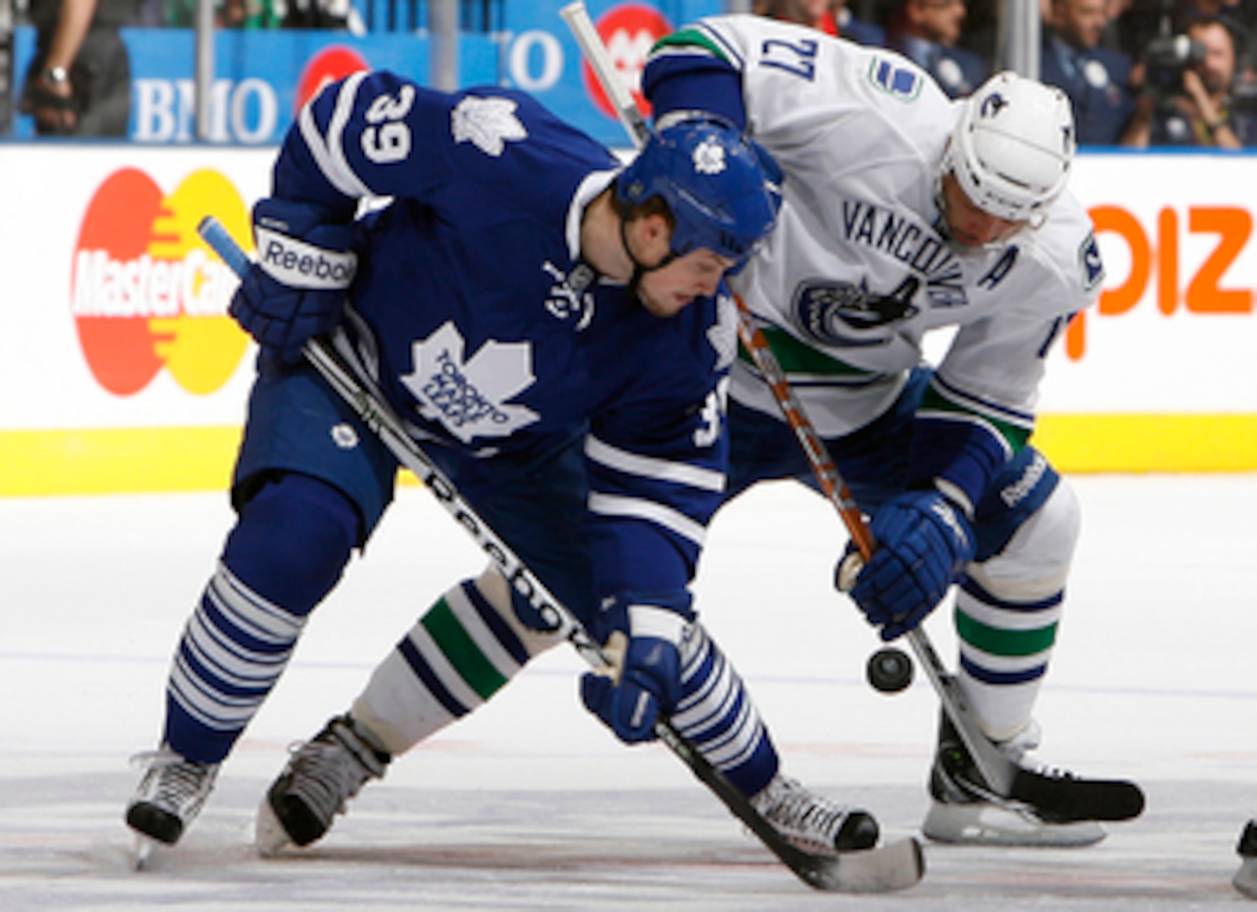 TORONTO - NOVEMBER 13: John Mitchell #39 of the Toronto Maple Leafs battles for the puck with Manny Malhotra #27 of the Vancouver Canucks during game action at the Air Canada Centre November 13, 2010 in Toronto, Ontario, Canada. (Photo by Abelimages / Get TORONTO - NOVEMBER 13: John Mitchell #39 of the Toronto Maple Leafs battles for the puck with Manny Malhotra #27 of the Vancouver Canucks during game action at the Air Canada Centre November 13, 2010 in Toronto, Ontario, Canada. (Photo by Abelimages / Get