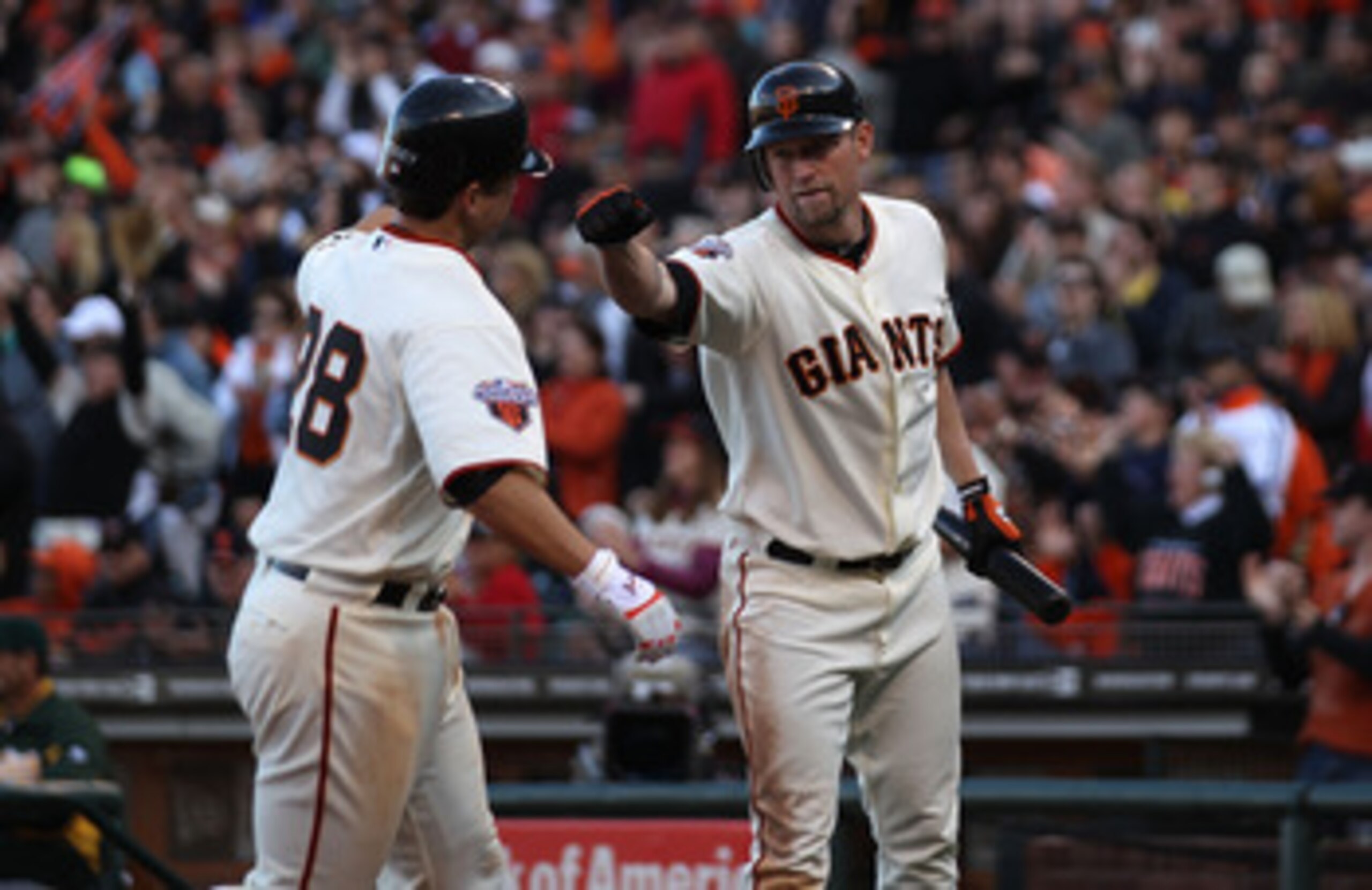 SAN FRANCISCO, CA - MAY 21:  Buster Posey #28 of the San Francisco Giants celebrates with Aubrey Huff #17 after scoring on a single by Cody Ross against the Oakland Athletics during an MLB game at AT&T Park on May 21, 2011 in San Francisco, California.  (