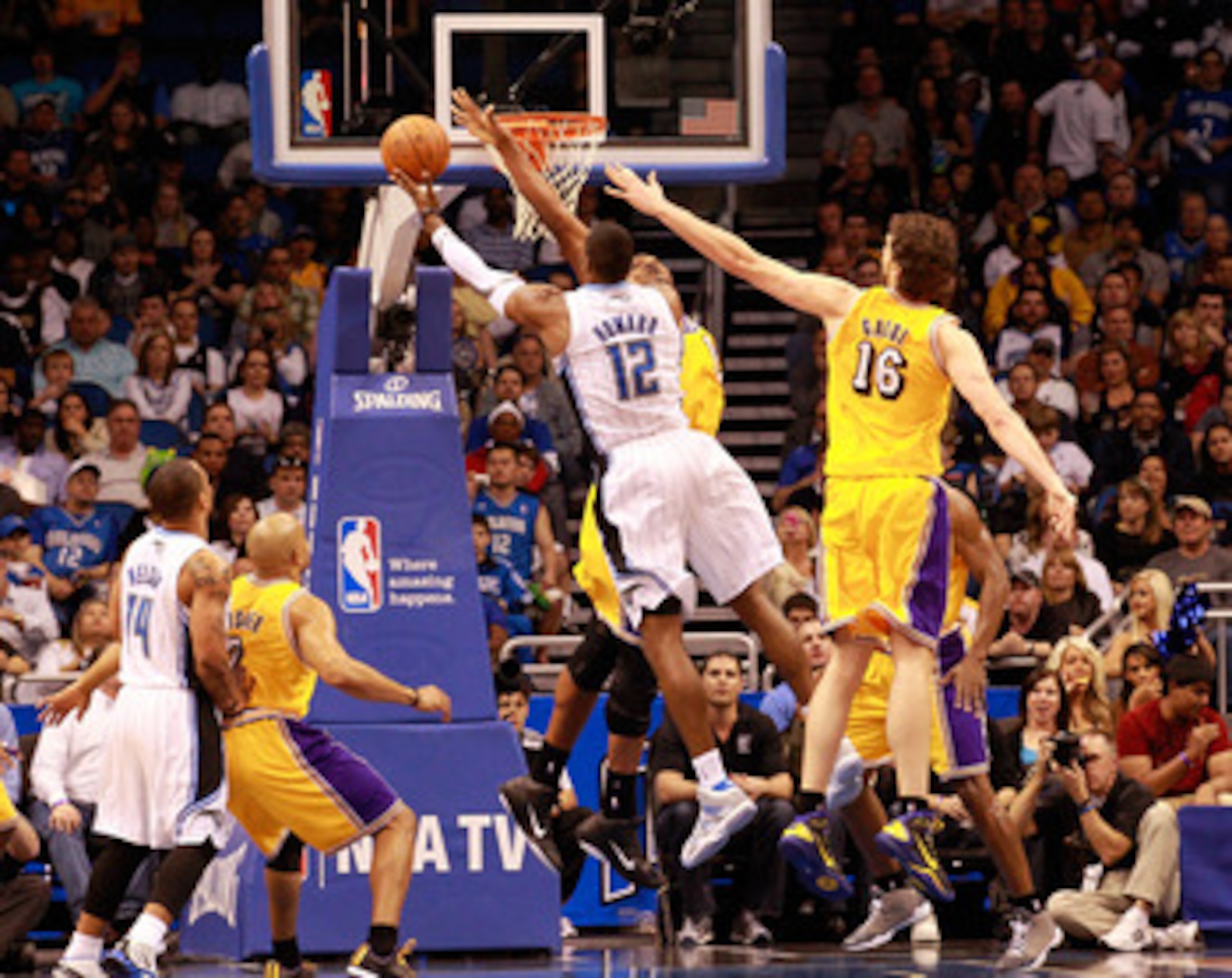 ORLANDO, FL - FEBRUARY 13:  Dwight Howard #12 of the Orlando Magic attempts a shot over Pau Gasol #16 and Andrew Bynum #17 of the Los Angeles Lakers during the game at Amway Arena on February 13, 2011 in Orlando, Florida.  NOTE TO USER: User expressly ack
