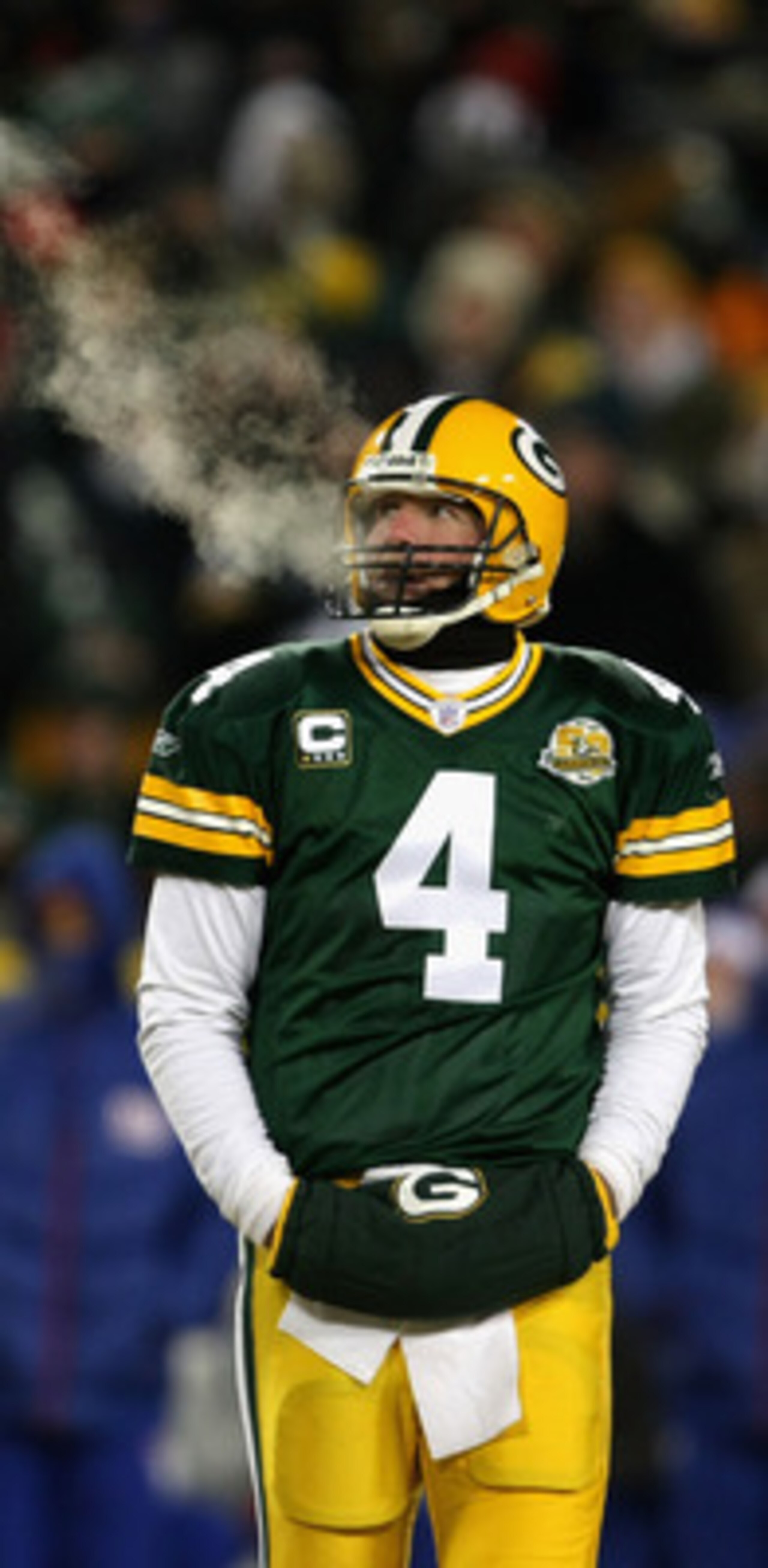GREEN BAY, WI - JANUARY 20:  Quarterback Brett Favre #4 of the Green Bay Packers warms his hand in between plays of the NFC championship game against the New York Giants on January 20, 2008 at Lambeau Field in Green Bay, Wisconsin.  (Photo by Jonathan Dan