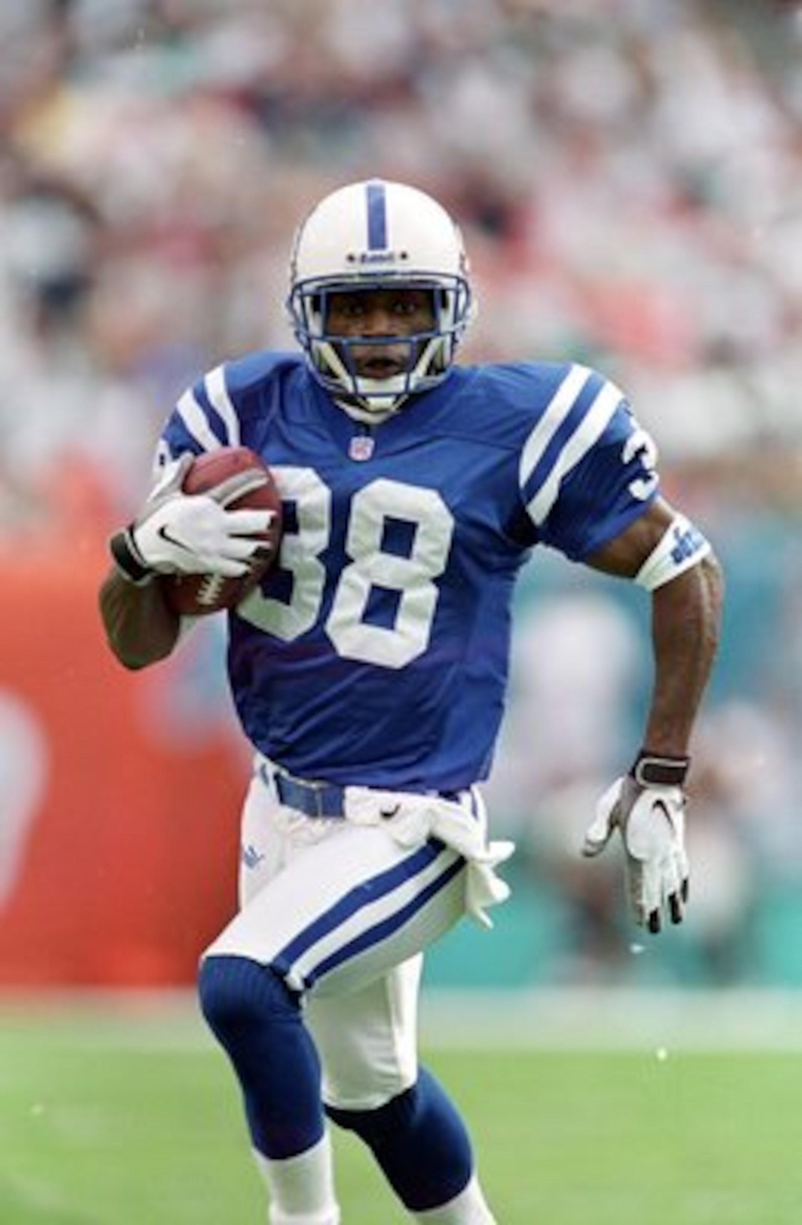 5 Dec 1999:  Tyrone Poole #38 of the Indianapolis Colts runs with the ball during the game against the Miami Dolphins at the Pro Player Stadium in Miami, Florida. The Colts defeated the Dolphins 37-34. Mandatory Credit: Andy Lyons  /Allsport