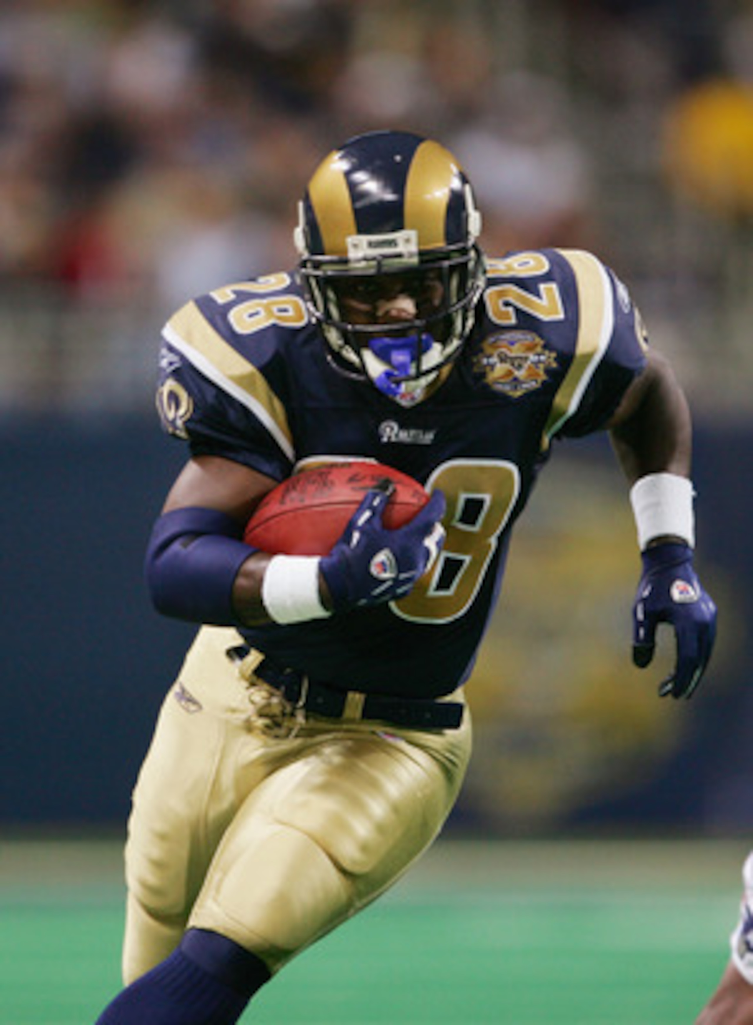 ST. LOUIS - NOVEMBER 7:   Running back Marshall Faulk #28 of the St. Louis Rams runs upfield against the New England Patriots on November 7, 2004 at the Edward Jones Dome in St. Louis, Missouri. The Patriots defeated the Rams 40-22. (Photo by Elsa/Getty I