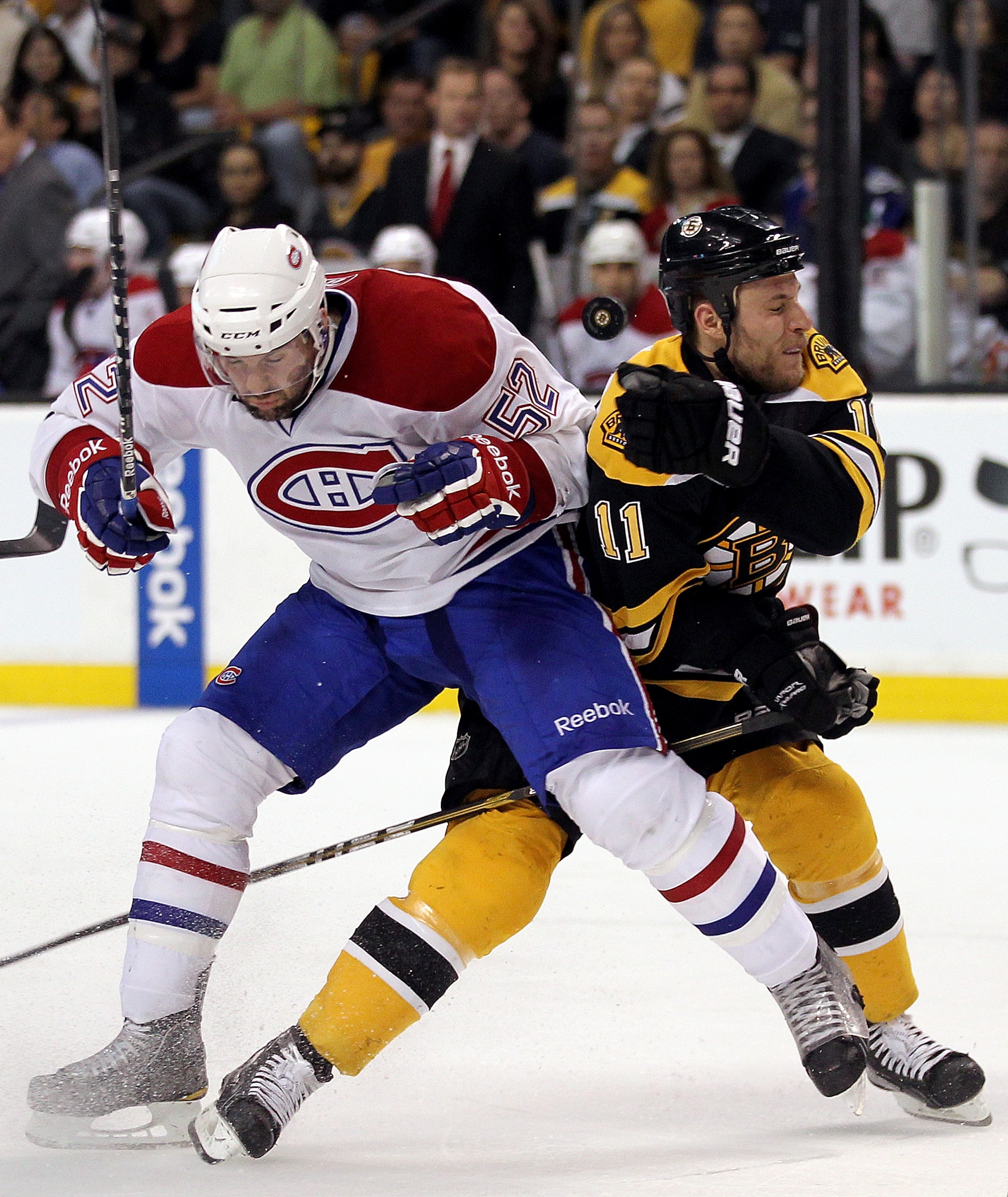 BOSTON, MA - APRIL 27:  Gregory Campbell #11 of the Boston Bruins battles Mathieu Darche #52 of the Montreal Canadiens in Game Seven of the Eastern Conference Quarterfinals during the 2011 NHL Stanley Cup Playoffs at TD Garden on April 27, 2011 in Boston,