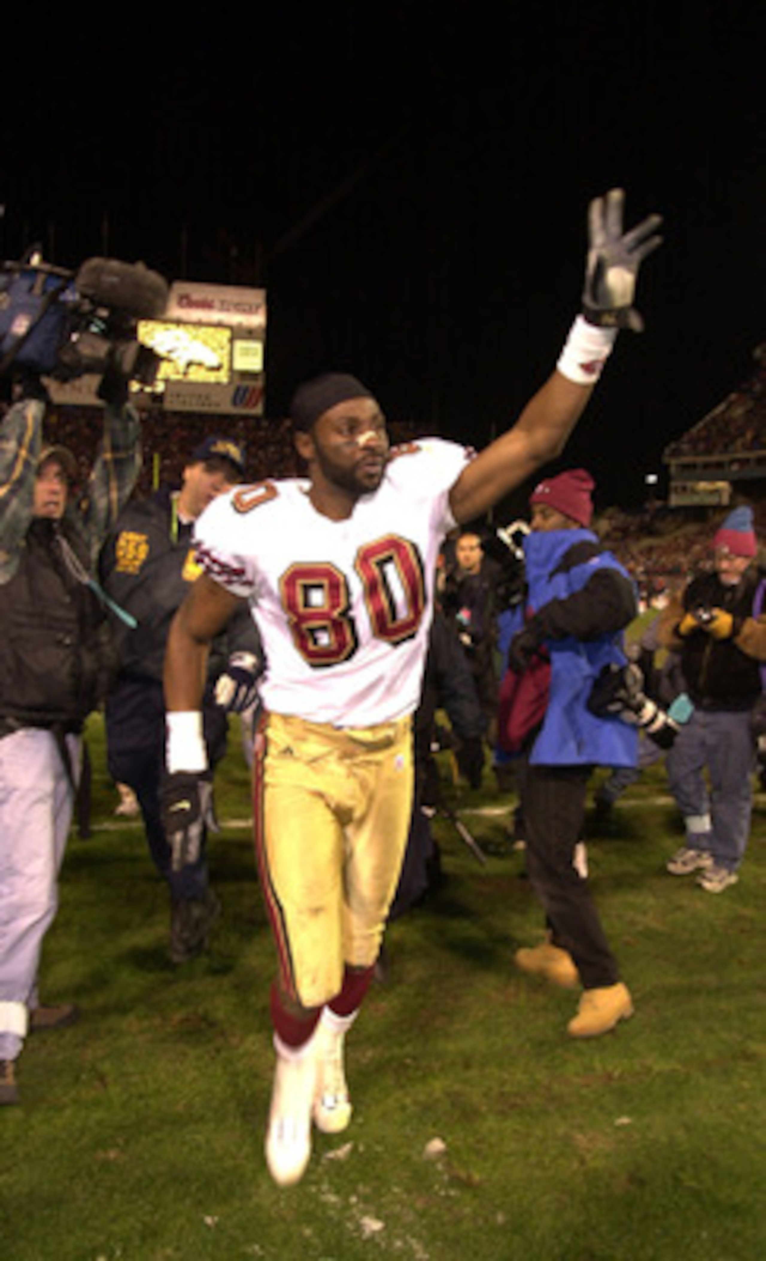 23 Dec 2000:  Jerry Rice #80 of the San Francisco 49ers waves to fans at the end of the game as he leaves the field, in perhaps his last game as a 49er, against the Denver Broncos at Mile High Stadium in Denver, Colorado.  The Broncos won 38-9.  DIGITAL I