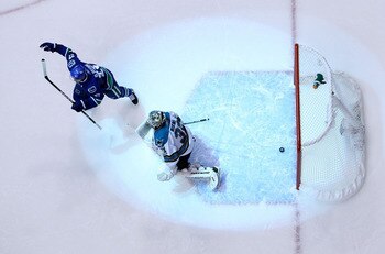 VANCOUVER, CANADA - MAY 24:  Goaltender Antti Niemi #31 of the San Jose Sharks looks on as Daniel Sedin #22 of the Vancouver Canucks celebrates after a deflection for a goal by Ryan Kesler #17 of the Vancouver Canucks (not in photo) sent the game into ove