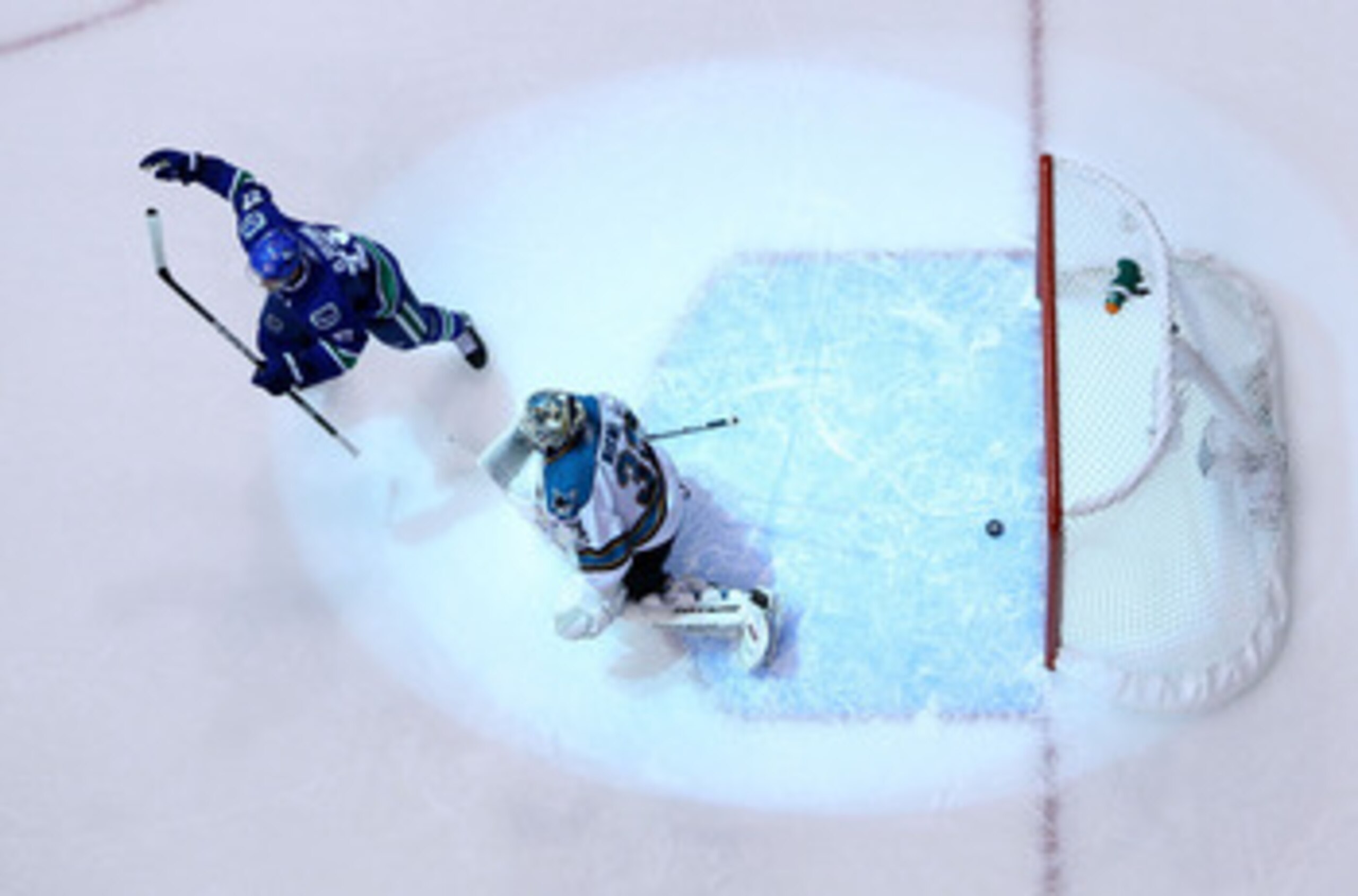 VANCOUVER, CANADA - MAY 24:  Goaltender Antti Niemi #31 of the San Jose Sharks looks on as Daniel Sedin #22 of the Vancouver Canucks celebrates after a deflection for a goal by Ryan Kesler #17 of the Vancouver Canucks (not in photo) sent the game into ove
