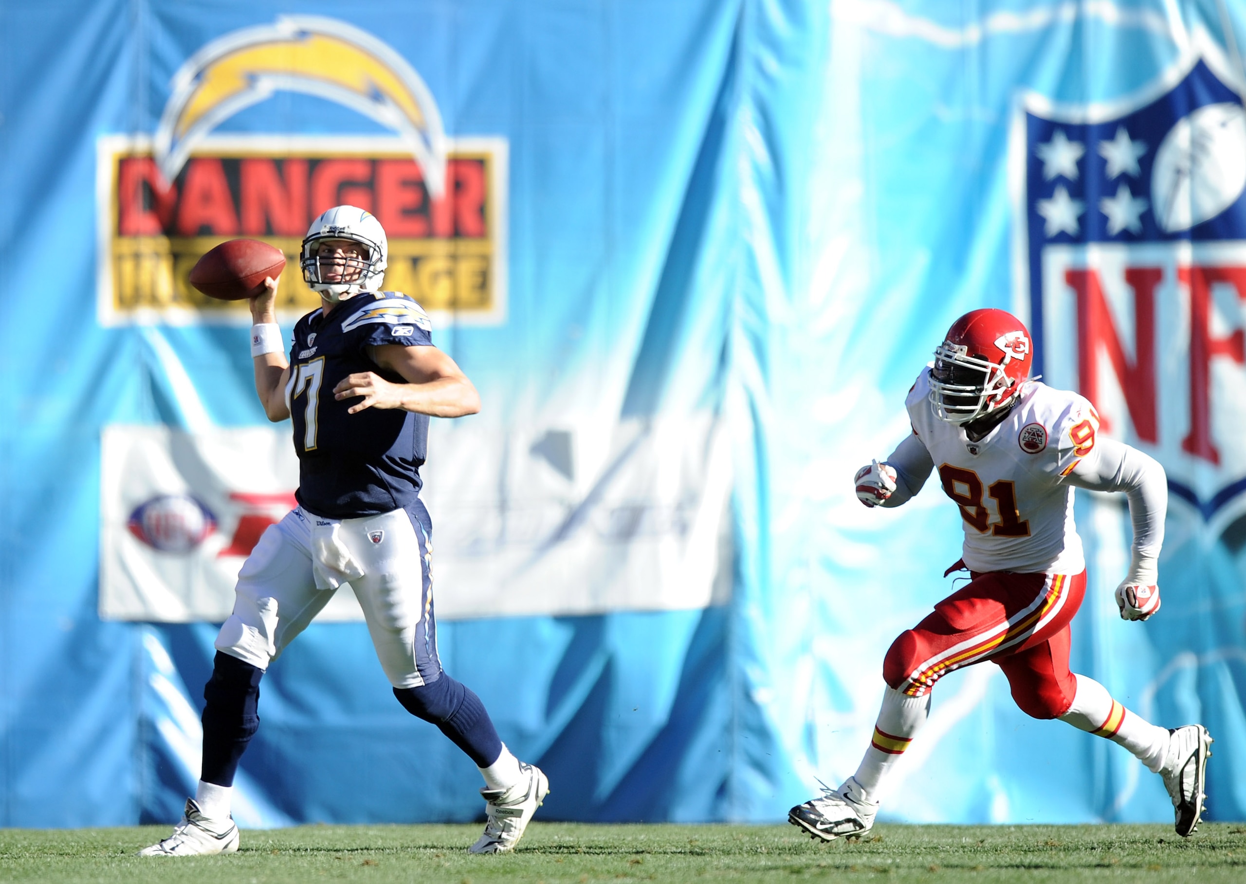 SAN DIEGO, CA - DECEMBER 12:  Philip Rivers #17 of the San Diego Chargers scrambles to throw from Tamba Hali #91 of the Kansas City Chiefs during the third quarter on way to a 31-0 Charger win at Qualcomm Stadium on December 12, 2010 in San Diego, Califor