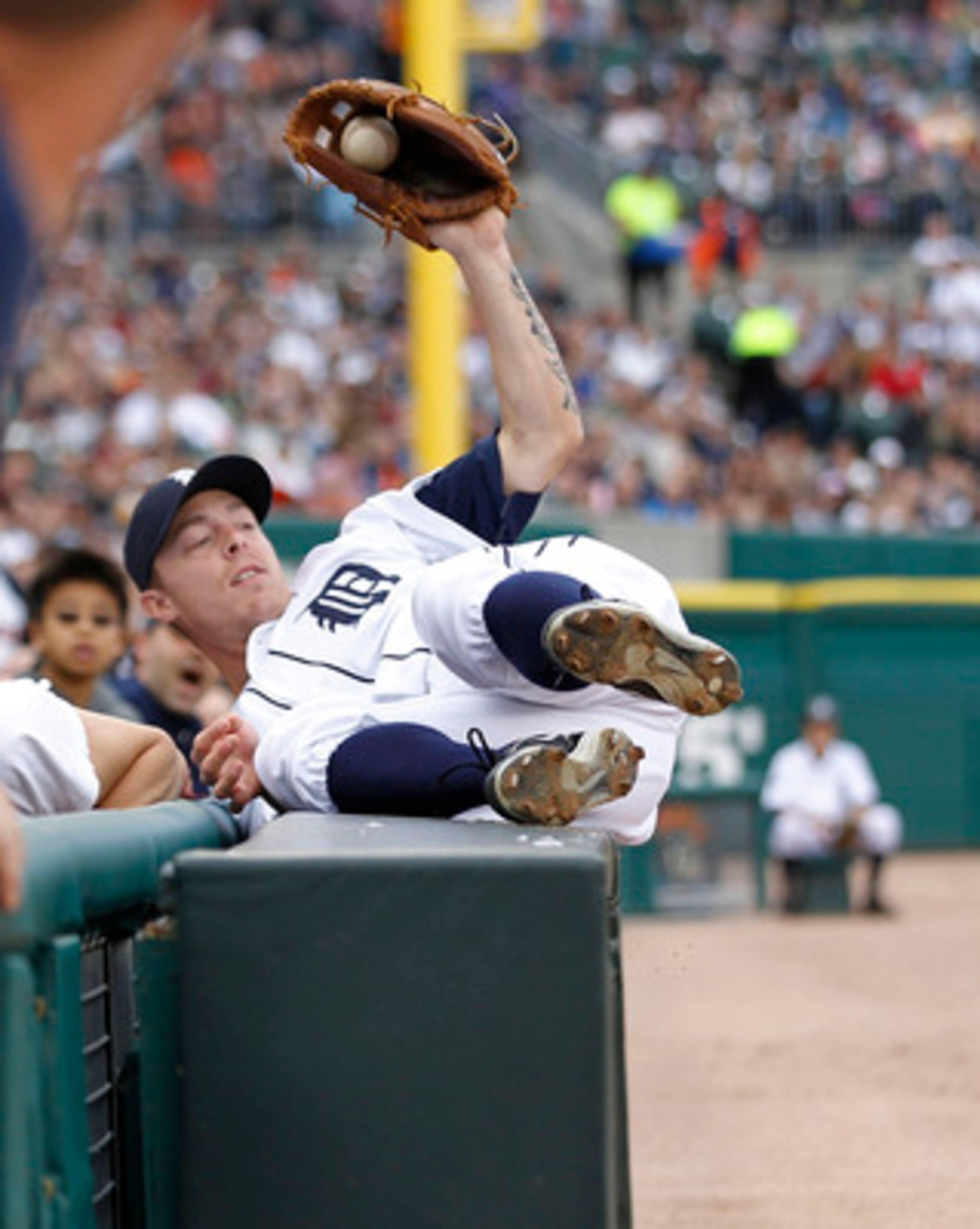 DETROIT - MAY 14: Brandon Inge #15 of the Detroit Tigers catches a foul ball against the stands off the bat of Brayan Pena #27 of the Kansas City Royals in the second inning of the game at Comerica Park on May 14, 2011 in Detroit, Michigan.  (Photo by Leo