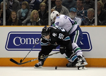 SAN JOSE, CA - MAY 22:  Kyle Wellwood #20 of the San Jose Sharks protects the puck from Maxim Lapierre #40 of the Vancouver Canucks in Game Four of the Western Conference Finals during the 2011 Stanley Cup Playoffs at HP Pavilion on May 22, 2011 in San Jo