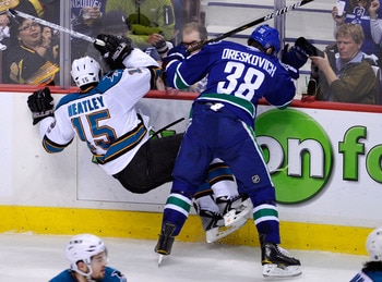 VANCOUVER, CANADA - MAY 24:  Victor Oreskovich #38 of the Vancouver Canucks checks Dany Heatley #15 of the San Jose Sharks in the first period in Game Five of the Western Conference Finals during the 2011 Stanley Cup Playoffs at Rogers Arena on May 24, 20