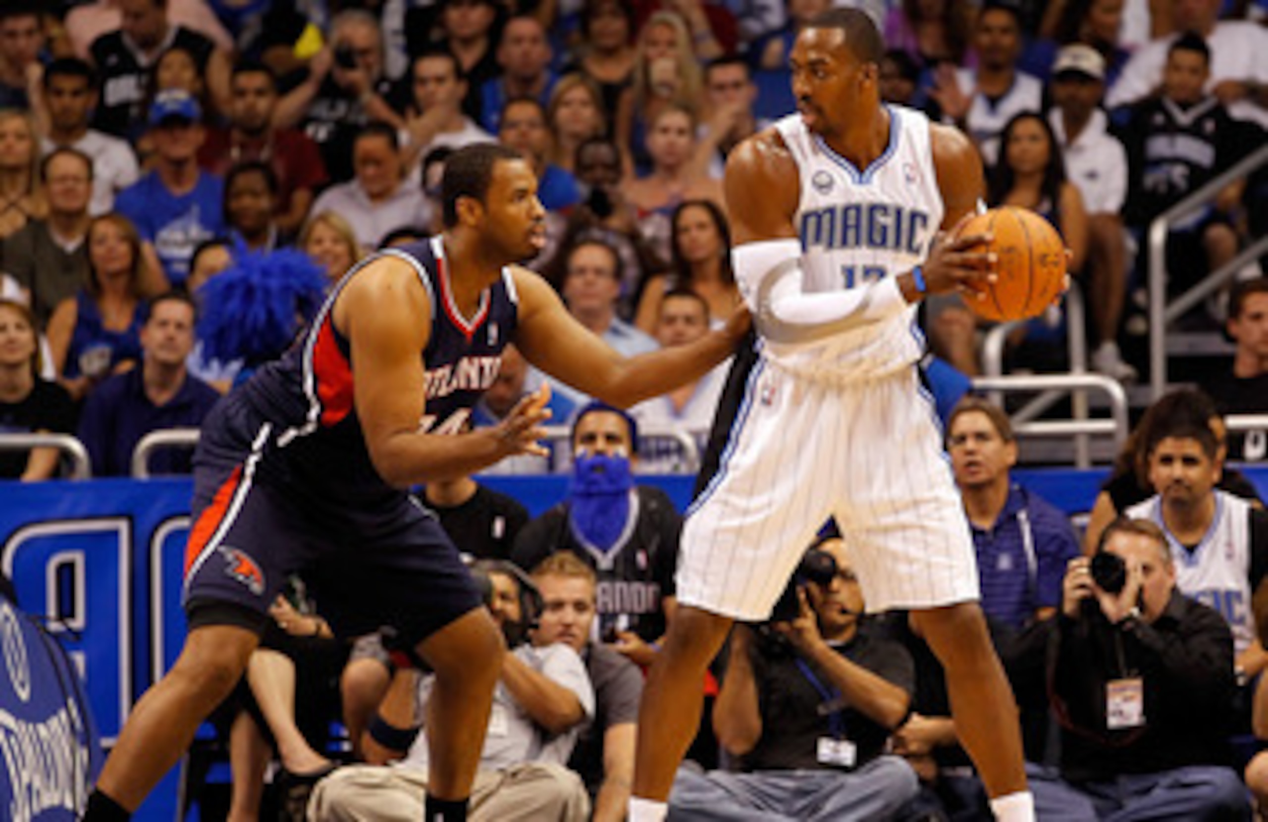 ORLANDO, FL - APRIL 26:  Jason Collins #34 of the Atlanta Hawks guards Dwight Howard #12 of the Orlando Magic during Game Five of the Eastern Conference Quarterfinals of the 2011 NBA Playoffs on April 26, 2011 at the Amway Arena in Orlando, Florida.  NOTE