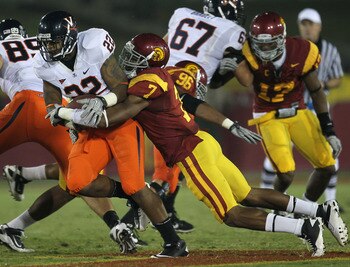 LOS ANGELES, CA - SEPTEMBER 11:  Safety T.J. McDonald #7 of the USC Trojans tackles running back Keith Payne #22 of the Virginia Cavaliers at Los Angeles Memorial Coliseum on September 11, 2010 in Los Angeles, California.  (Photo by Stephen Dunn/Getty Ima