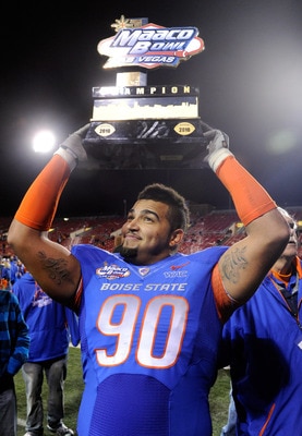 LAS VEGAS, NV - DECEMBER 22:  Billy Winn #90 of the Boise State Broncos holds up a trophy as he celebrates the team's 26-3 victory over the Utah Utes in the MAACO Bowl Las Vegas at Sam Boyd Stadium December 22, 2010 in Las Vegas, Nevada.  (Photo by Ethan