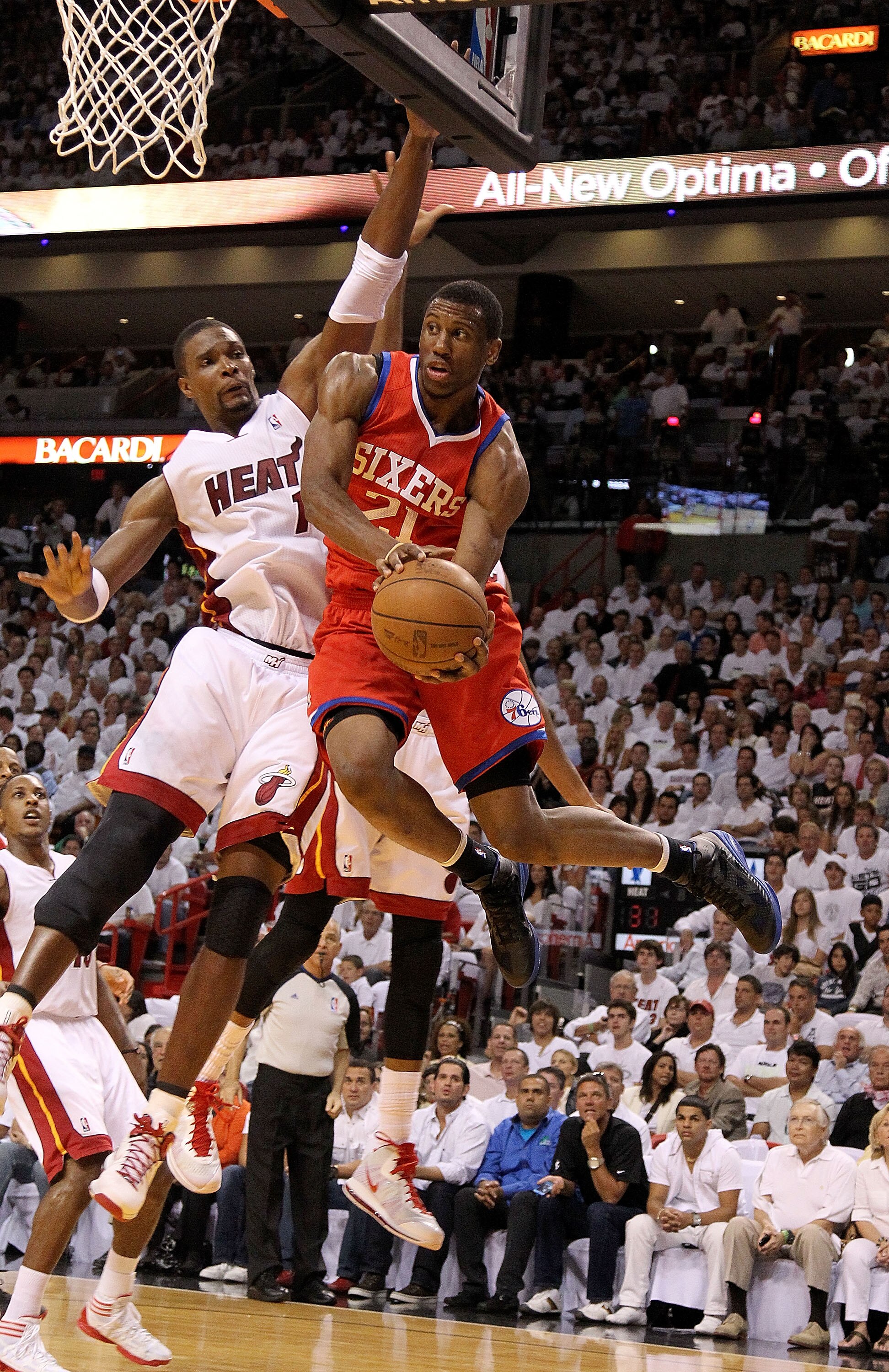 MIAMI, FL - APRIL 27:  Thaddeus Young #21 of the Philadelphia 76ers drives past Chris Bosh #1 of the Miami Heat during game five of the Eastern Conference Quarterfinals in the 2011 NBA Playoffs at American Airlines Arena on April 27, 2011 in Miami, Florid