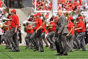COLUMBUS, OH - SEPTEMBER 05:  Former U.S. Senator John Glenn (D-OH) and his wife Annie Glenn walk off the field after dotting the 'i' as the Ohio State Alumni Marching Band forms script Ohio during halftime of a game against the Navy Midshipmen at Ohio St