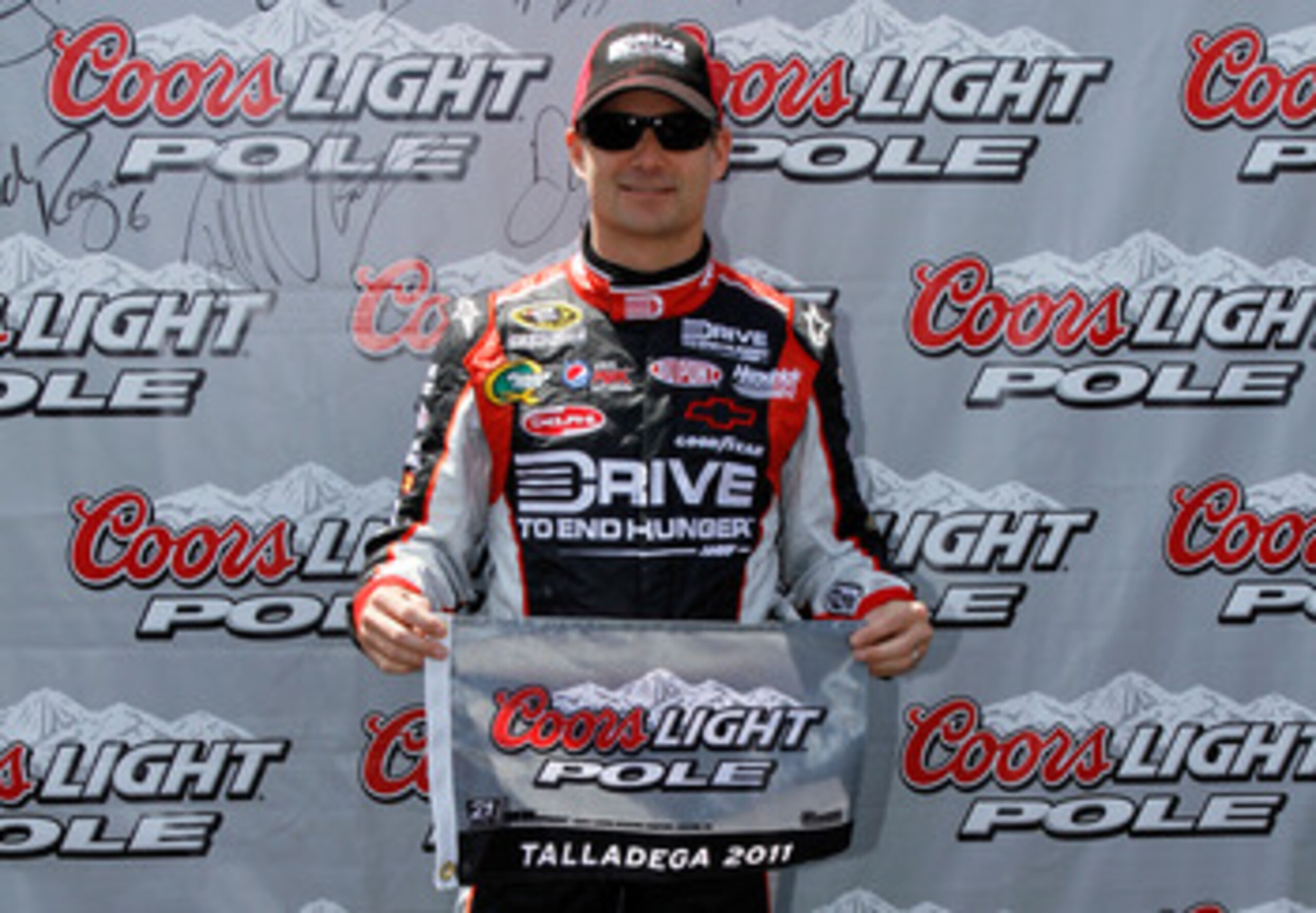 TALLADEGA, AL - APRIL 16:  Jeff Gordon, driver of the #24 Drive to End Hunger/AARP Chevrolet, poses after qualifying for the pole position in the NASCAR Sprint Cup Series Aaron's 499 at Talladega Superspeedway on April 16, 2011 in Talladega, Alabama.  (Ph