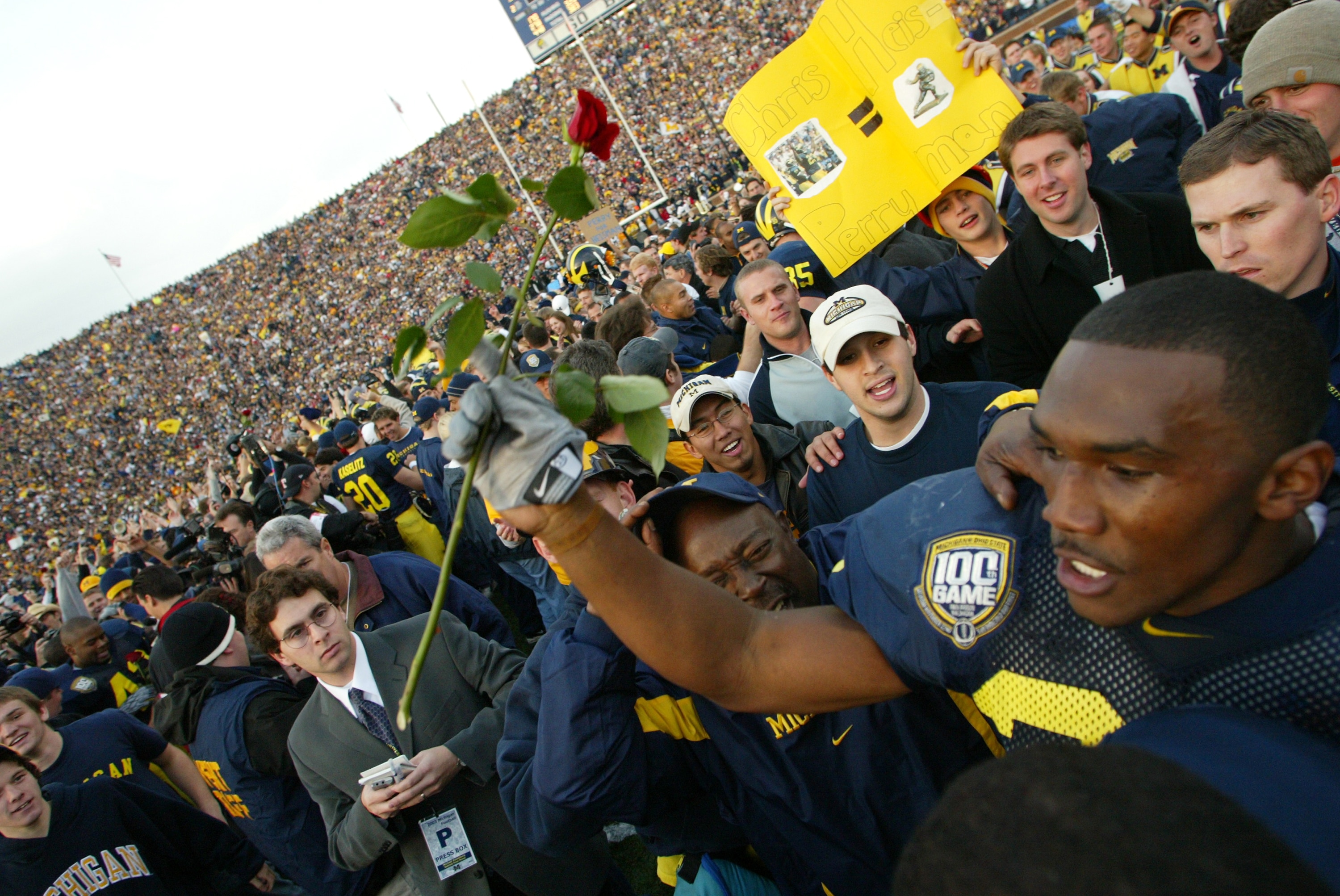 ANN ARBOR, MI - NOVEMBER 22:  Running Back Chris Perry #23 of the Michigan Wolverines celebrates with a rose as fans rush the field after a 35-21 win the Ohio State Buckeyes giving Michigan the Big Ten Championship during the 100th meeting of the two team