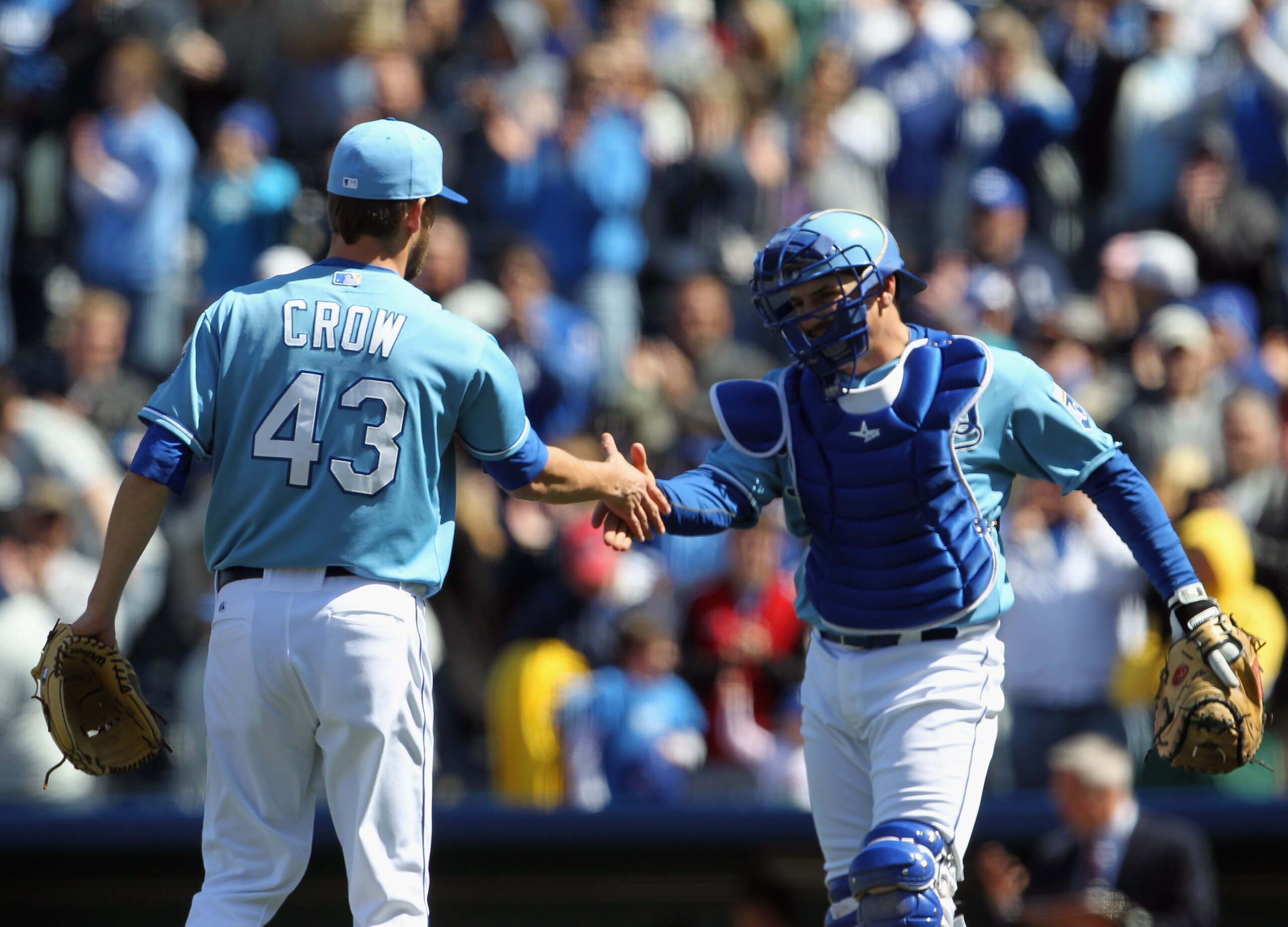 KANSAS CITY, MO - APRIL 16:  Closing pitcher Aaron Crow #43 of the Kansas City Royals is congratulated by Matt Treanor #15 after the Royals defeated the Seattle Mariners 7-0 to win the game on April 16, 2011 at Kauffman Stadium in Kansas City, Missouri.