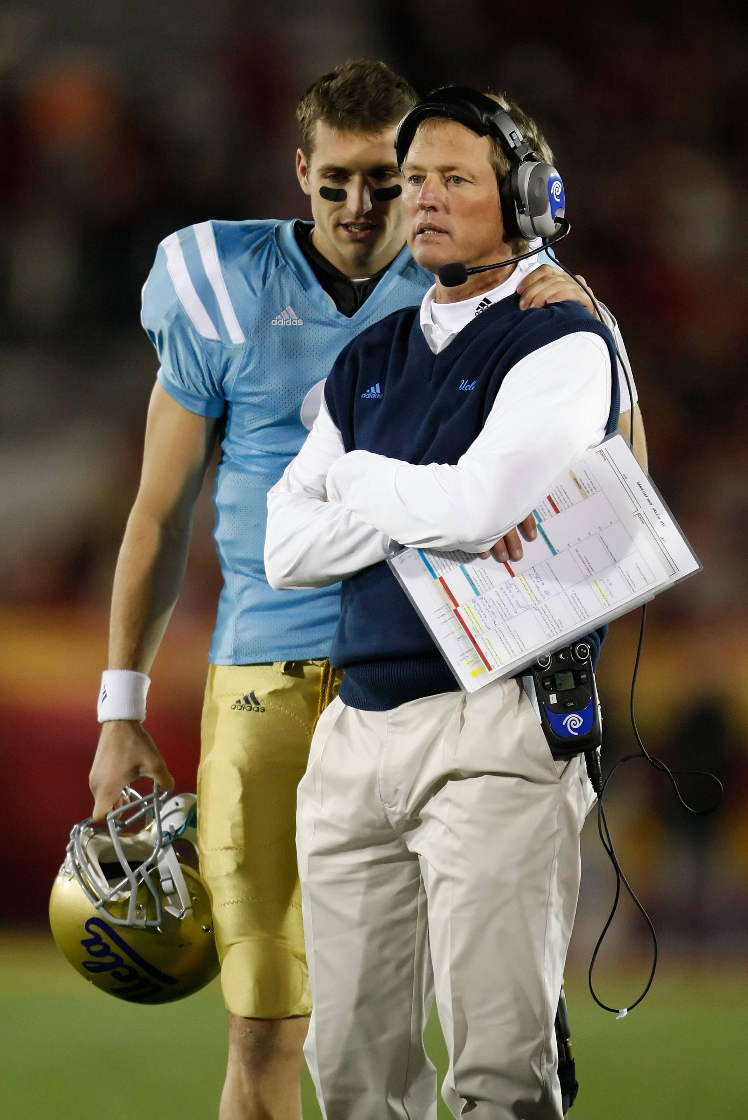 LOS ANGELES, CA - NOVEMBER 28:  Kevin Craft #3 speaks with UCLA Bruins head coach Rick Neuheisel in the second half against the USC Trojans at the Los Angeles Memorial Coliseum on November 28, 2009 in Los Angeles, California. USC defeated UCLA 28-7.  (Pho