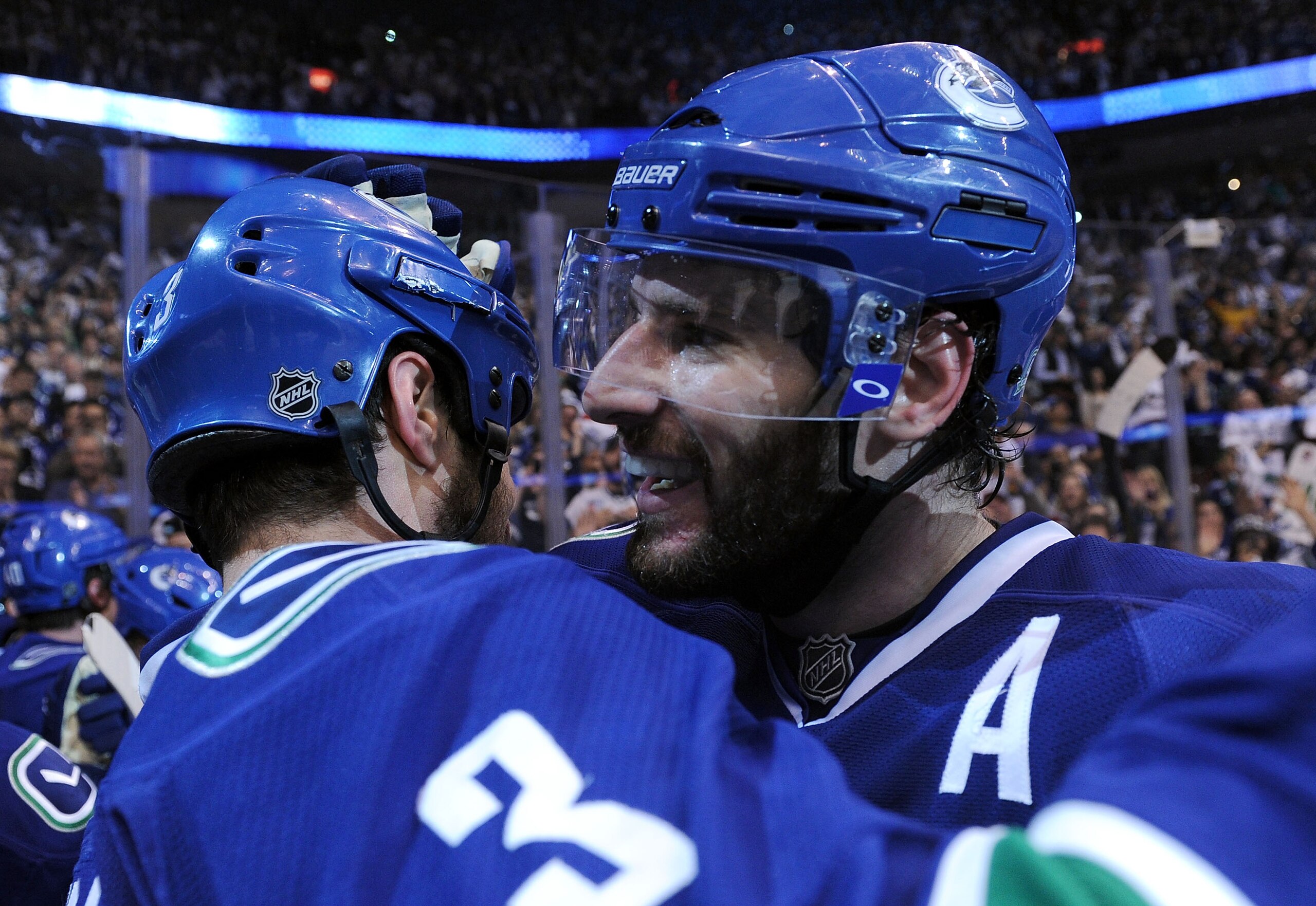 VANCOUVER, CANADA - MAY 24:  Ryan Kesler #17 of the Vancouver Canucks hugs teammate Kevin Bieksa #3 after defeating the San Jose Sharks 3-2 in double-overtime in Game Five to win the Western Conference Finals 4-1 during the 2011 Stanley Cup Playoffs at Ro