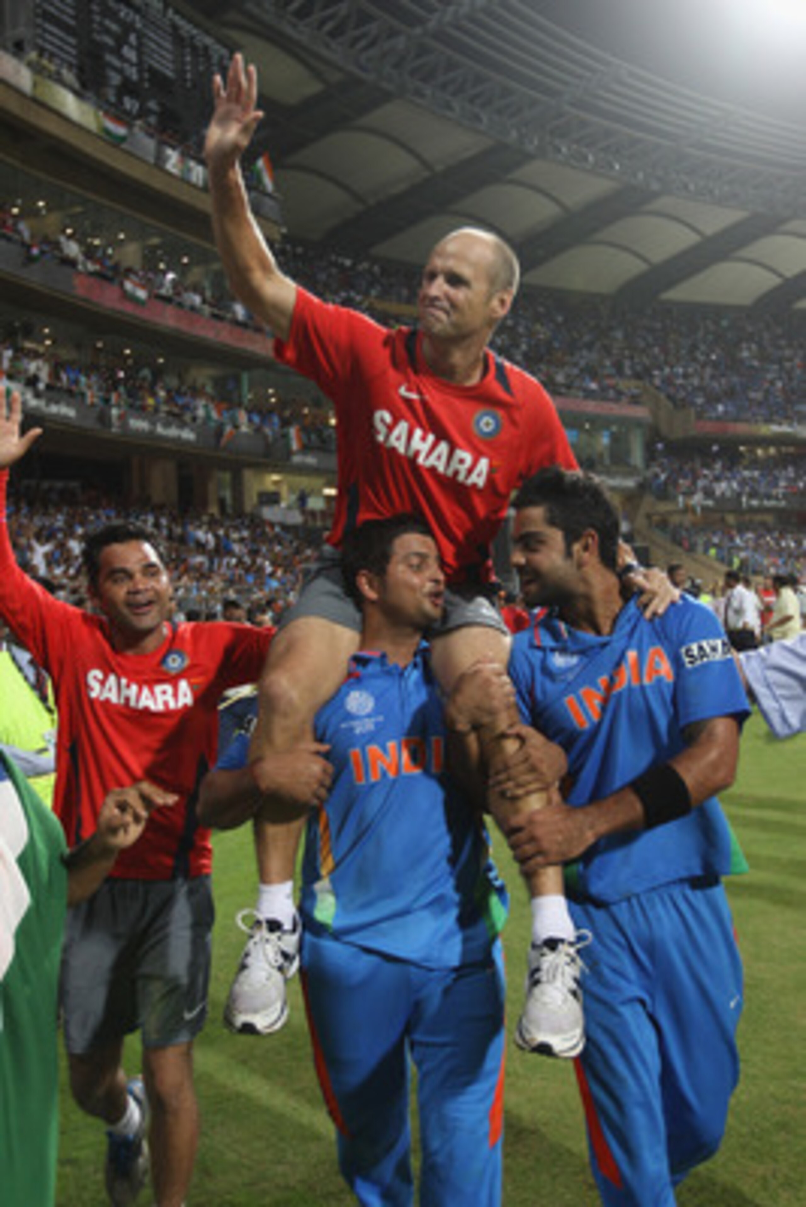 MUMBAI, INDIA - APRIL 02:  Gary Kirsten the coach of India is lifted by Suresh Raina (L) and Virat Kohli (R) during the 2011 ICC World Cup Final between India and Sri Lanka at Wankhede Stadium on April 2, 2011 in Mumbai, India.  (Photo by Michael Steele/G