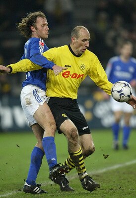 DORTMUND, GERMANY - JANUARY 30:  Niels Oude Kamphuis of Dortmund in action against Jan Koller of Schalke during the Bundsliga match between Borussia Dortmund and  FC Schalke 04 at The Westfallen Stadium on 30 January, 2004 in Dortmund, Germany. (Photo by
