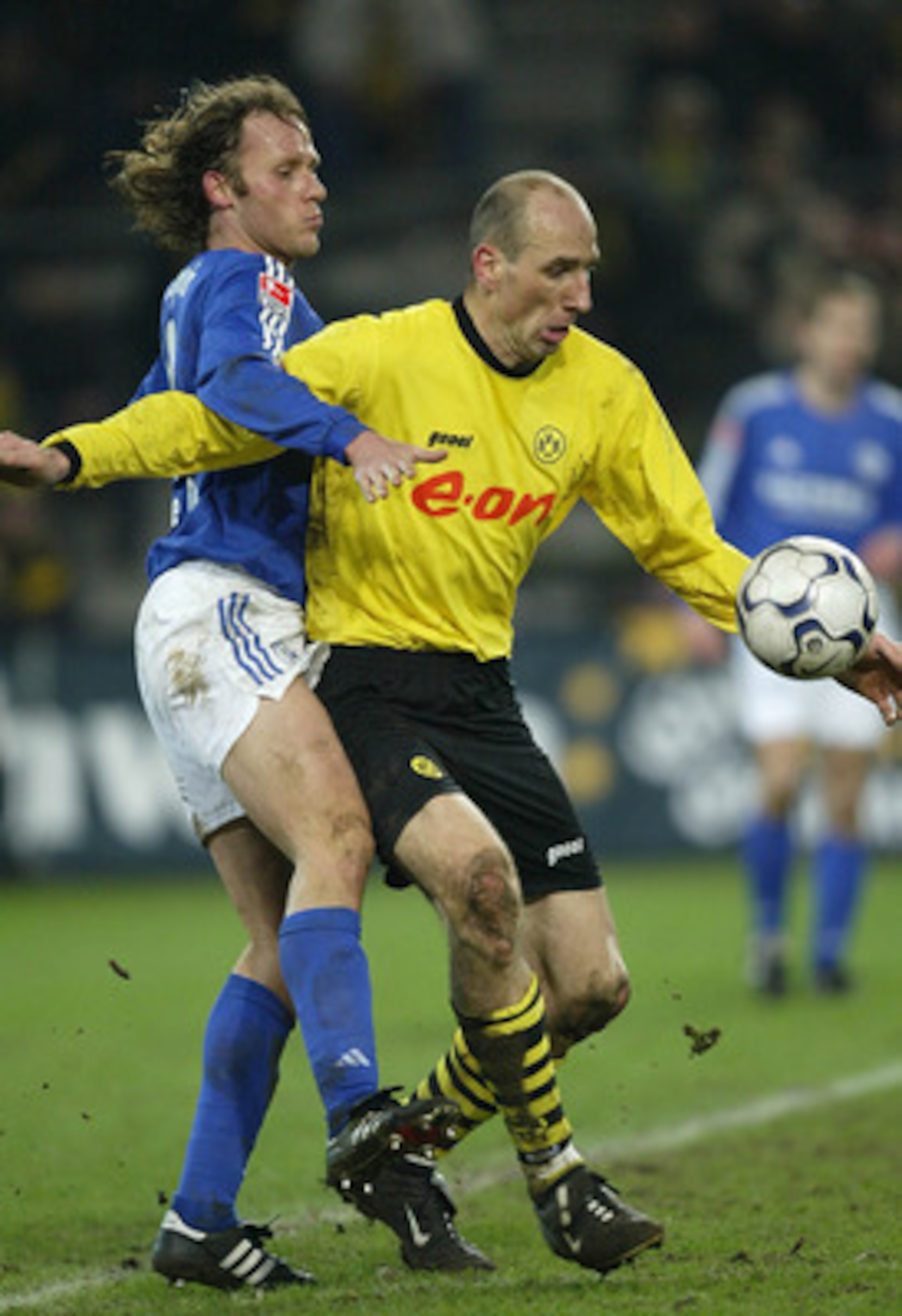 DORTMUND, GERMANY - JANUARY 30:  Niels Oude Kamphuis of Dortmund in action against Jan Koller of Schalke during the Bundsliga match between Borussia Dortmund and  FC Schalke 04 at The Westfallen Stadium on 30 January, 2004 in Dortmund, Germany. (Photo by