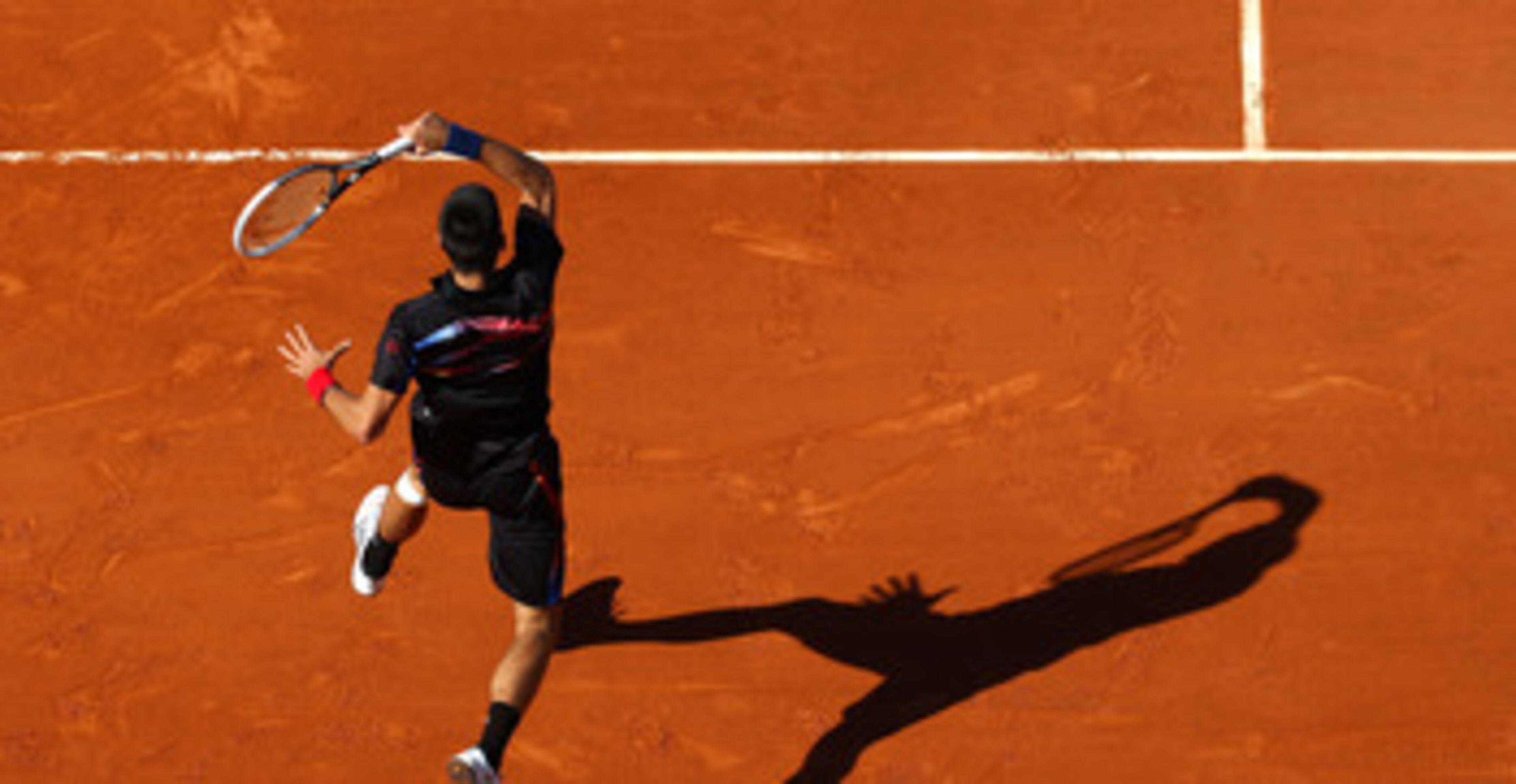 PARIS, FRANCE - MAY 25:  Novak Djokovic of Serbia hts a forehand during the men's singles round two match between Victor Hanescu of Romania and Novak Djokovic of Serbia on day four of the French Open at Roland Garros on May 25, 2011 in Paris, France.  (Ph