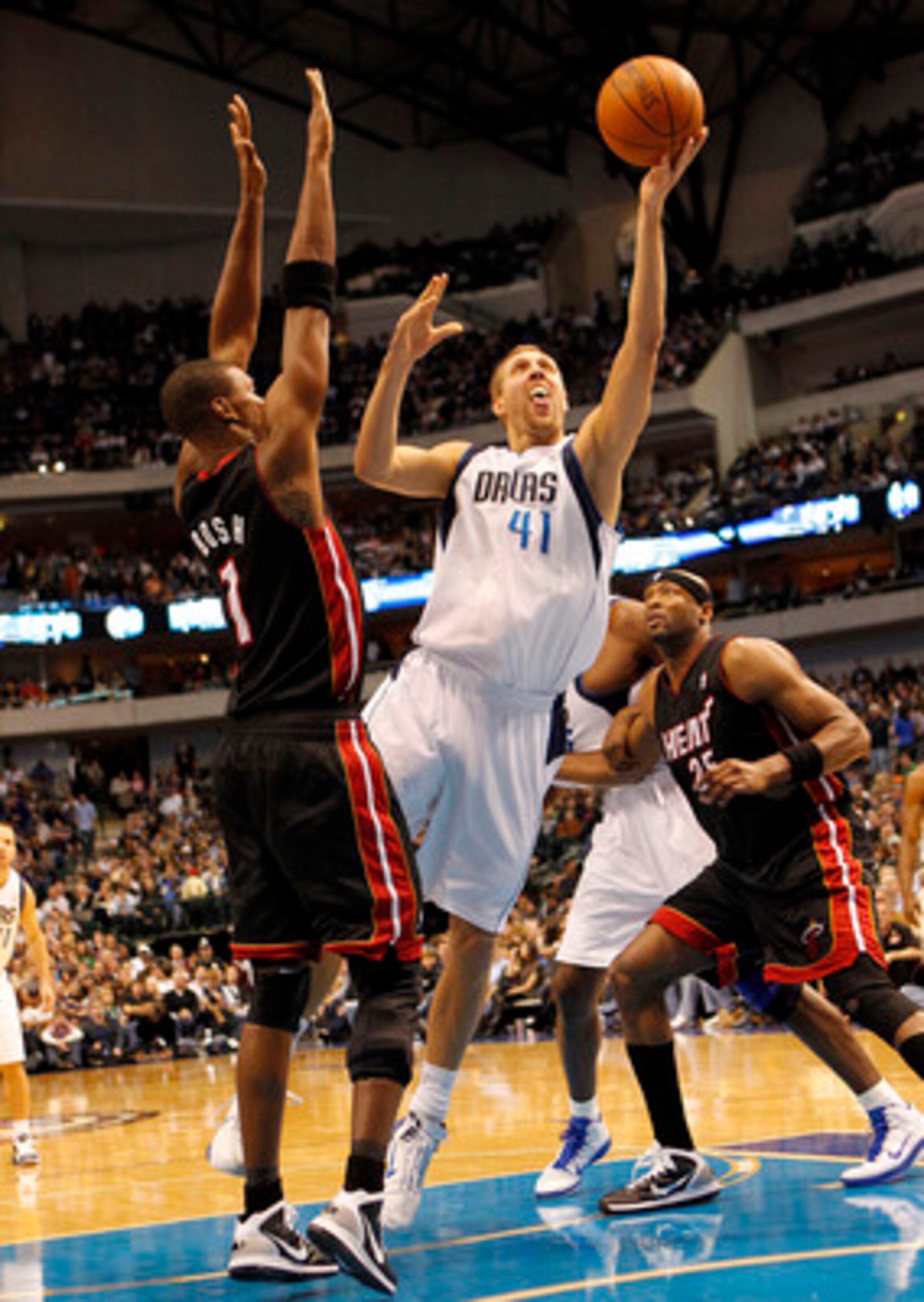 DALLAS - NOVEMBER 27: Dirk Nowitzki #41 of the Dallas Mavericks shoots over Chris Bosh #1 of the Miami Heat on November 27, 2010 at the American Airlines Center in Dallas, Texas. NOTE TO USER: User expressly acknowledges and agrees that, by downloading an
