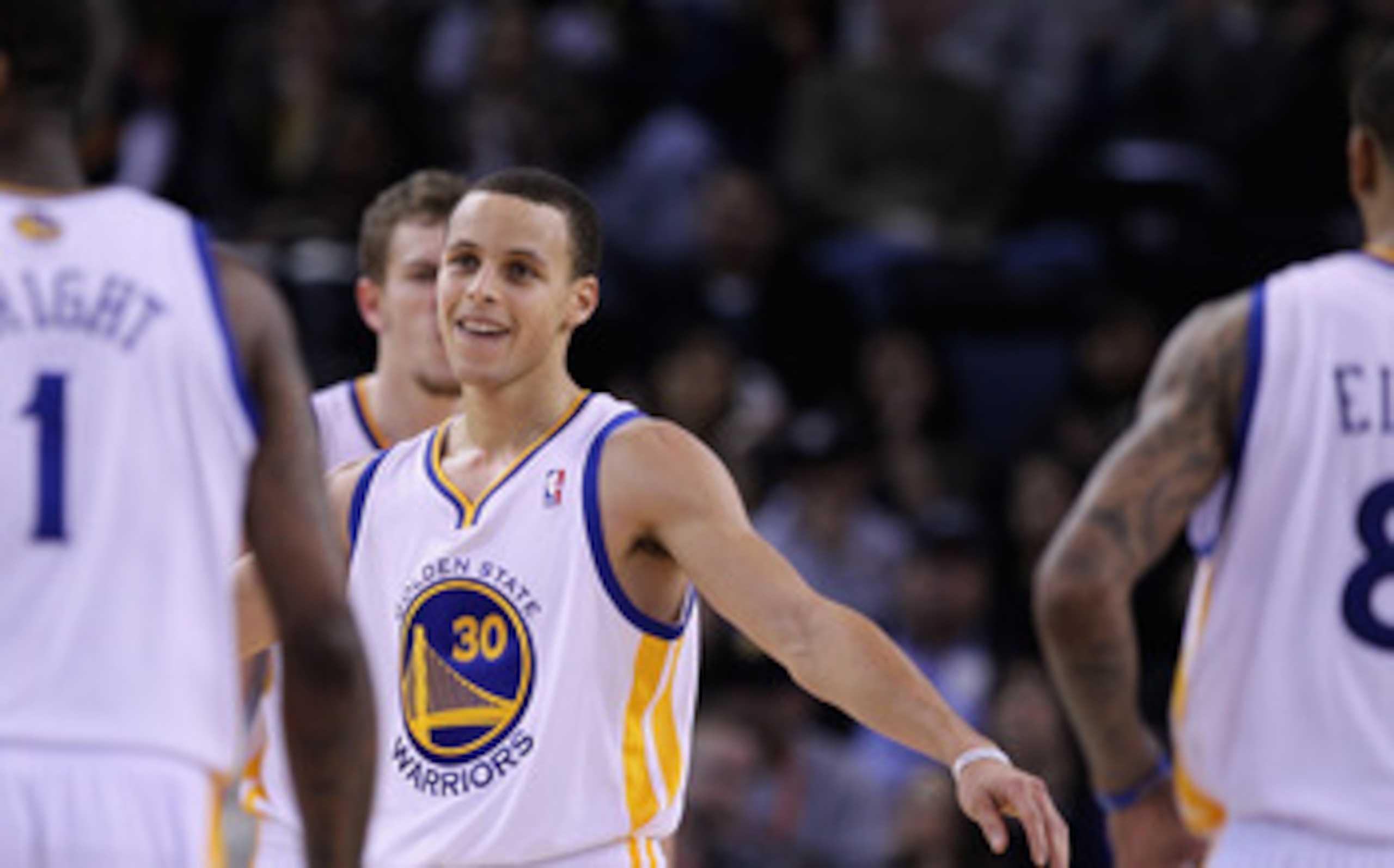 OAKLAND, CA - MARCH 25:  Stephen Curry #30 of the Golden State Warriors congratulates his teammates during their game against the Toronto Raptors at Oracle Arena on March 25, 2011 in Oakland, California. NOTE TO USER: User expressly acknowledges and agree