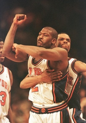 23 Apr 2000: Larry Johnson #2 of the New York Knicks is hugged from behind by teammate Latrell Sprewell after Johnson hit a three-point basket to give the Knicks a 88-85 win over the Toronto Raptors at Madison Square Garden in New York City. The Knicks le