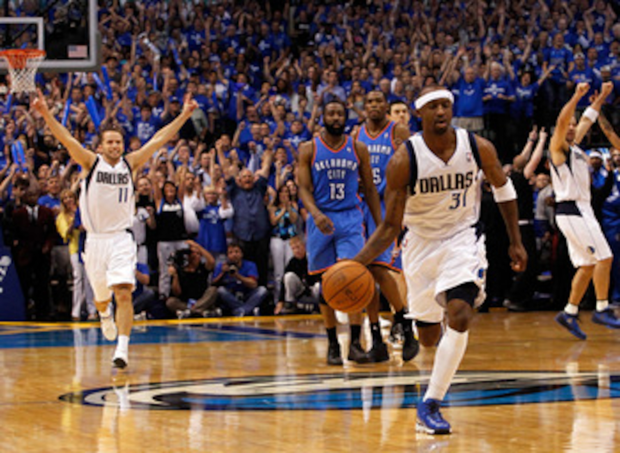 DALLAS, TX - MAY 25:  Jason Terry #31 of the Dallas Mavericks moves the ball down court as Jose Juan Barea #11 celebrates as the the Mavericks defeat the the Oklahoma City Thunder 100-96 in Game Five of the Western Conference Finals during the 2011 NBA Pl