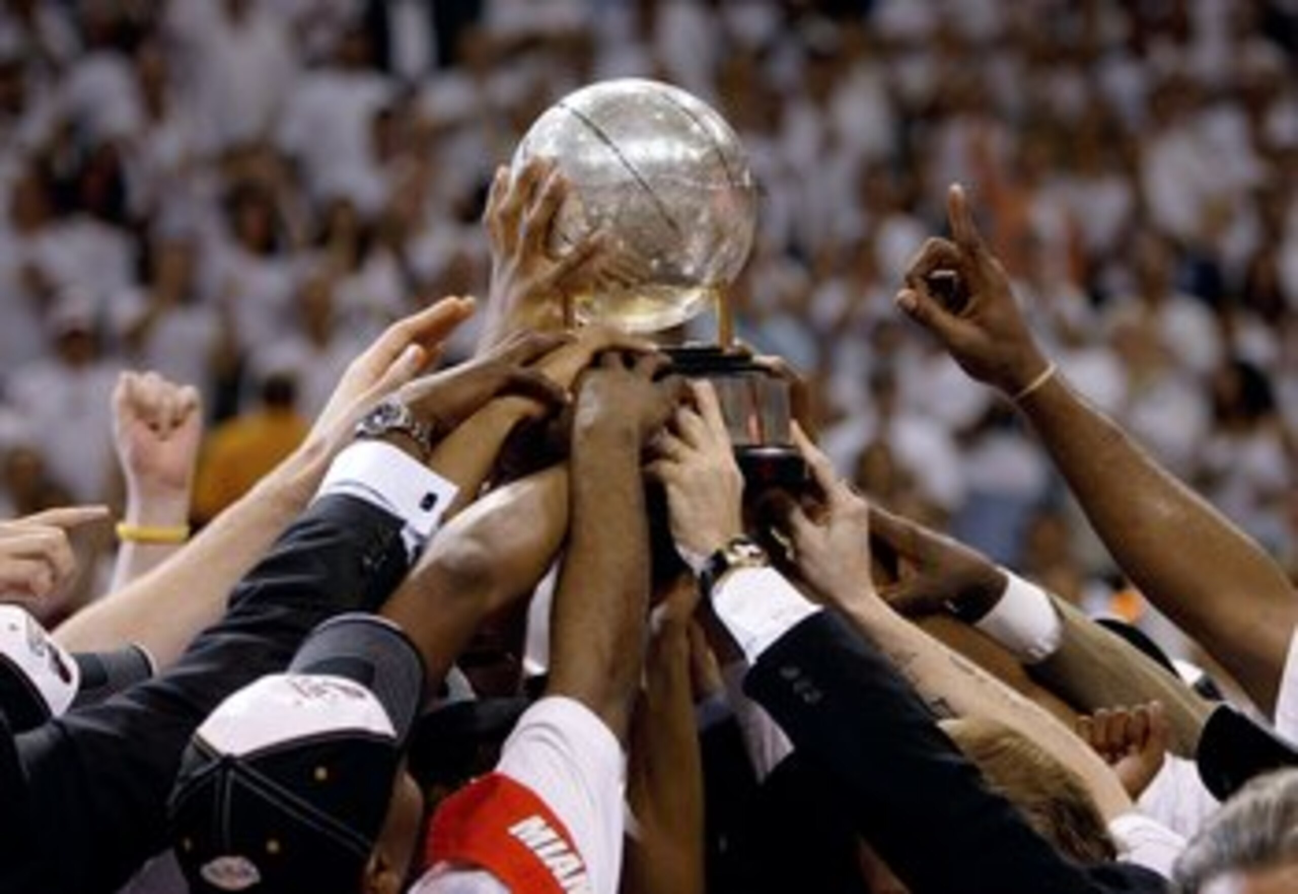 MIAMI - JUNE 2: The Miami Heat hold up the Eastern Conference Championship Trophy after defeating the Detroit Pistons in game six of the Eastern Conference Finals during the 2006 NBA Playoffs on June 2, 2006 at American Airlines Arena in Miami, Florida. T
