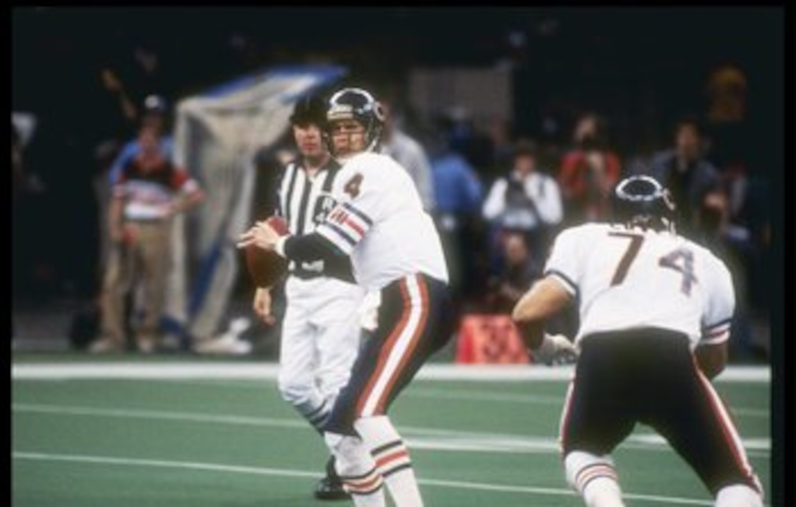 26  Jan 1986:   Quarterback Steve Fuller #4 of the New England Patriots prepares to pass as teammate offensive lineman Jim Covert #74 covers during Super Bowl  XX  game with the Chicago Bears at the Louisiana Superdome in New Orleans, Louisiana.  The Bear