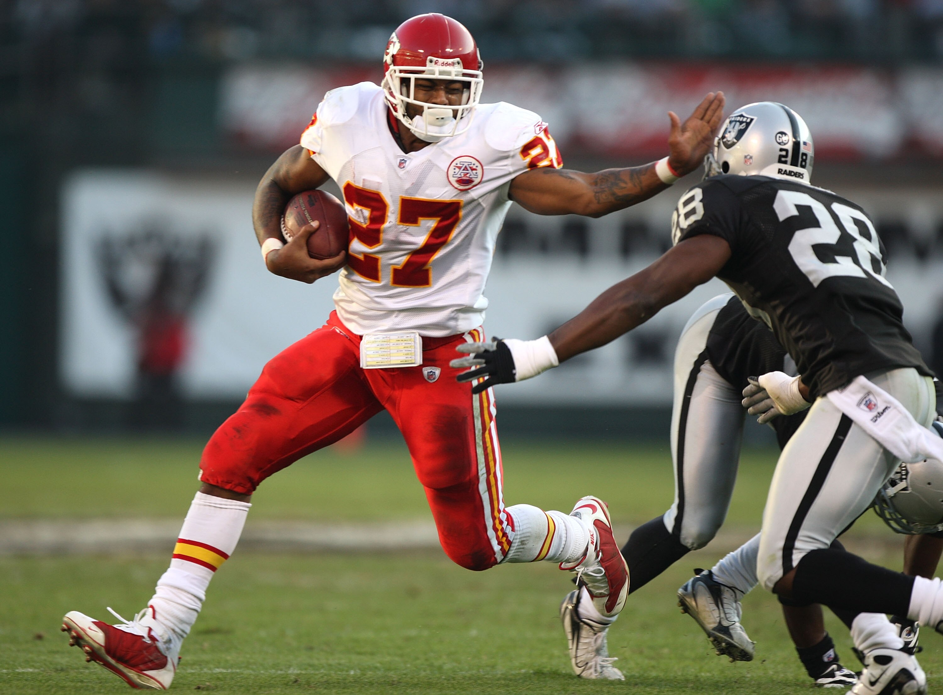 OAKLAND, CA - NOVEMBER 30:  Larry Johnson #27 of the Kansas City Chiefs runs against Gibril Wilson #28 of the Oakland Raiders during an NFL game on November 30, 2008 at the Oakland-Alameda County Coliseum in Oakland, California.  (Photo by Jed Jacobsohn/G