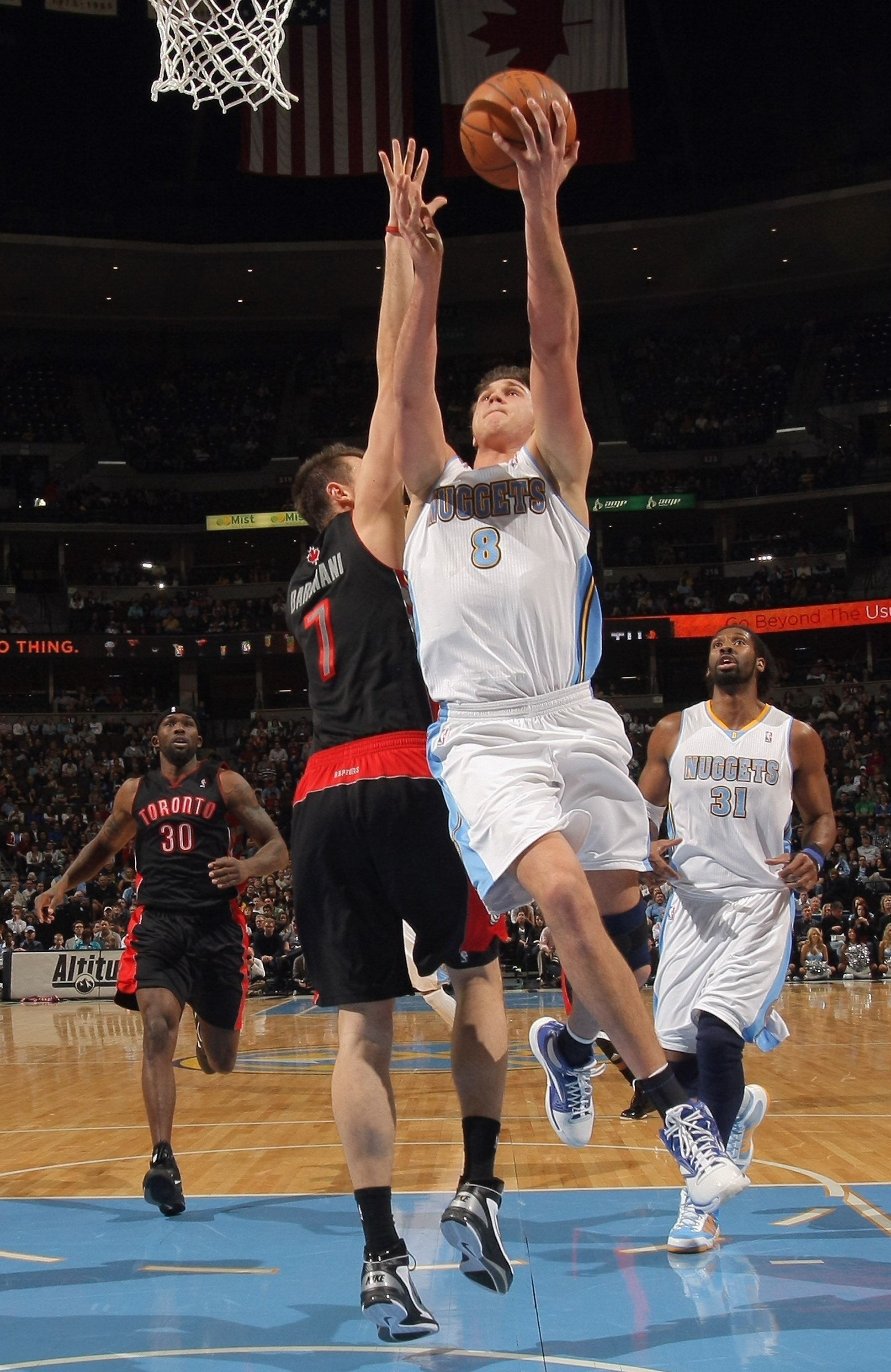 DENVER, CO - MARCH 21:  Danilo Gallinari #8 of the Denver Nuggets takes a shot against the defense of Andrea Bargnani #7 of the Toronto Raptors at the Pepsi Center on March 21, 2011 in Denver, Colorado. NOTE TO USER: User expressly acknowledges and agrees