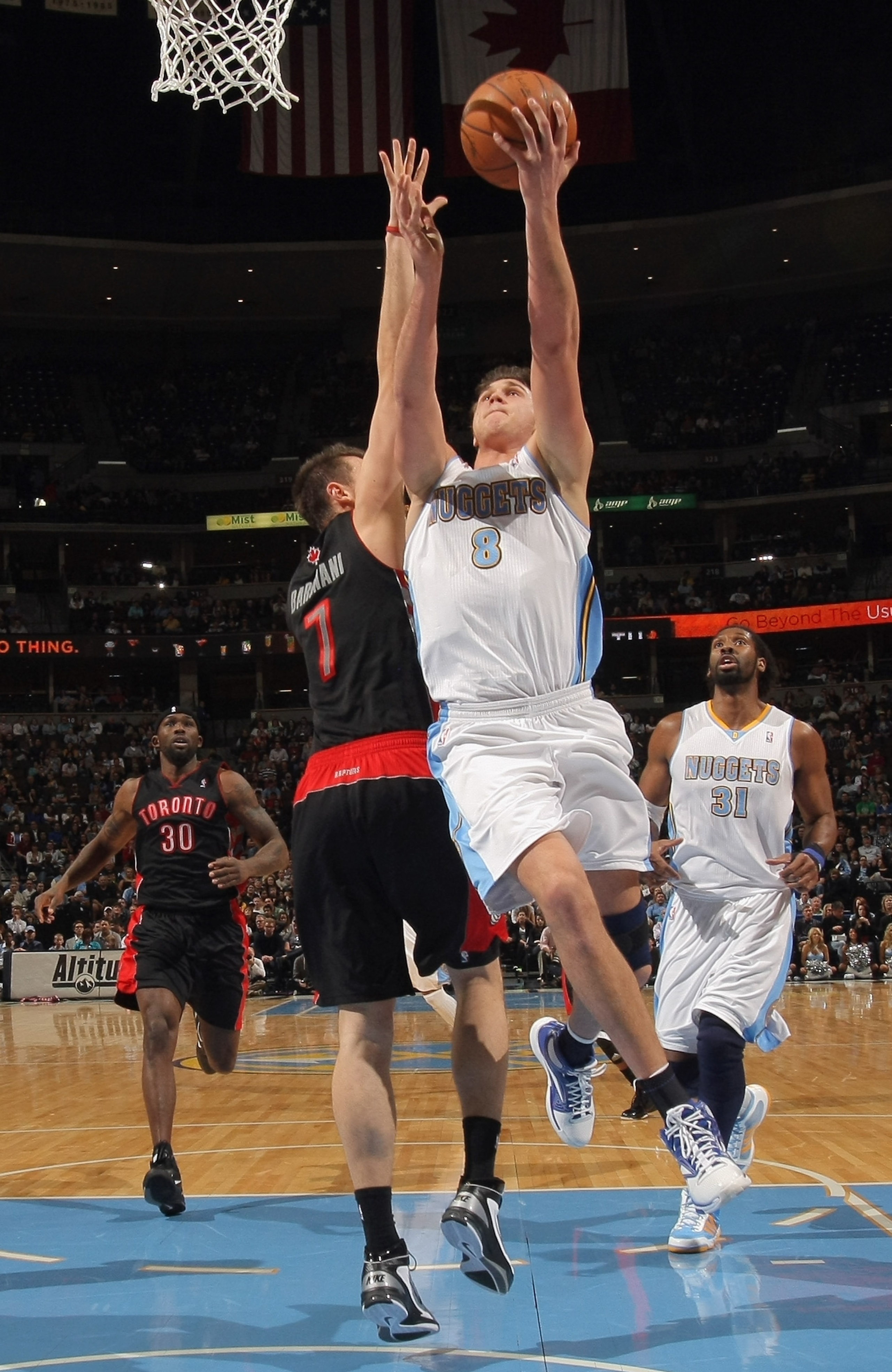 DENVER, CO - MARCH 21:  Danilo Gallinari #8 of the Denver Nuggets takes a shot against the defense of Andrea Bargnani #7 of the Toronto Raptors at the Pepsi Center on March 21, 2011 in Denver, Colorado. NOTE TO USER: User expressly acknowledges and agrees