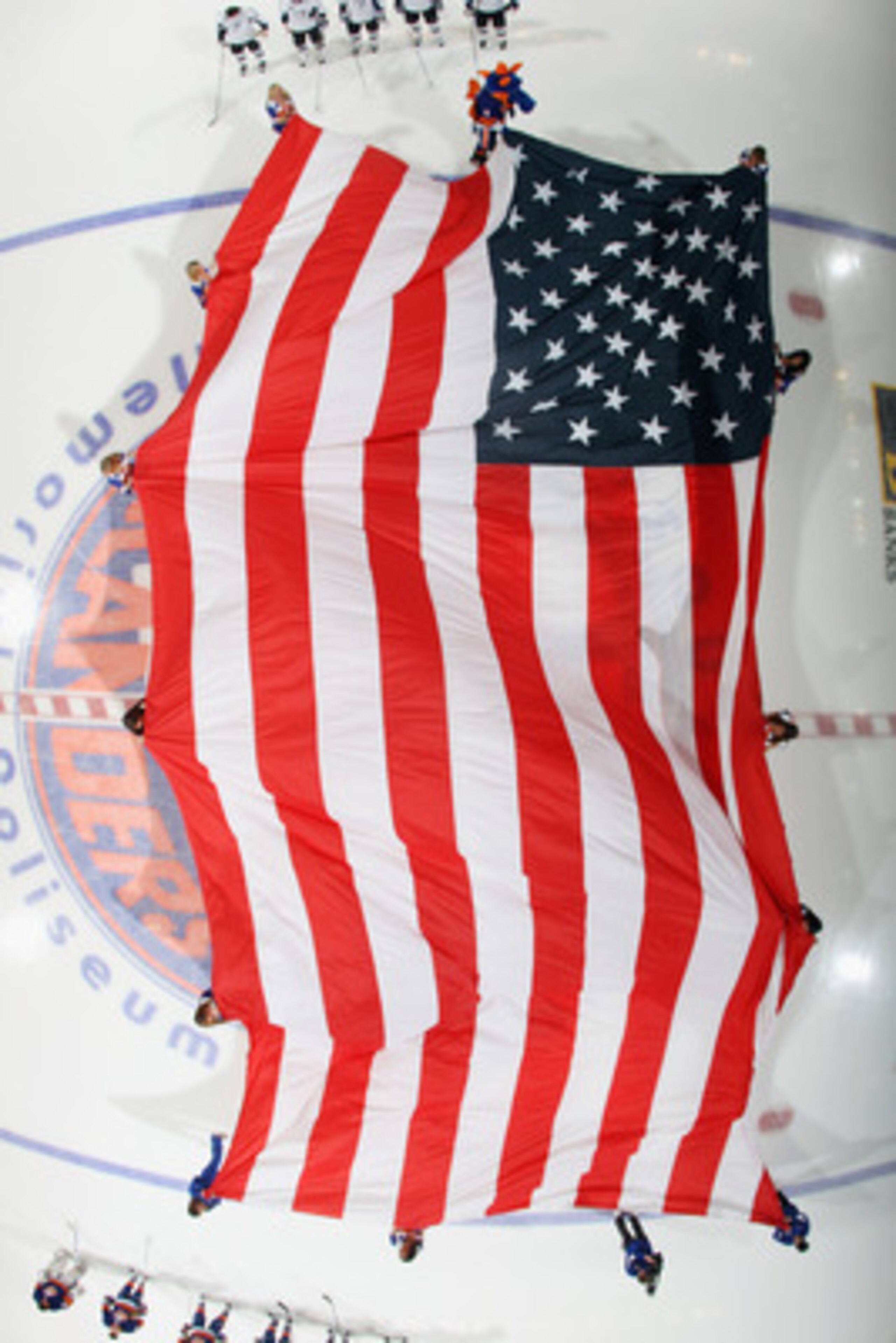 UNIONDALE, NY - NOVEMBER 17:  A large American flag is unfurled prior to the game between the New York Islanders and the Tampa Bay Lightning at the Nassau Coliseum on November 17, 2010 in Uniondale, New York. The Lightning defeated the Islanders 4-2. (Pho