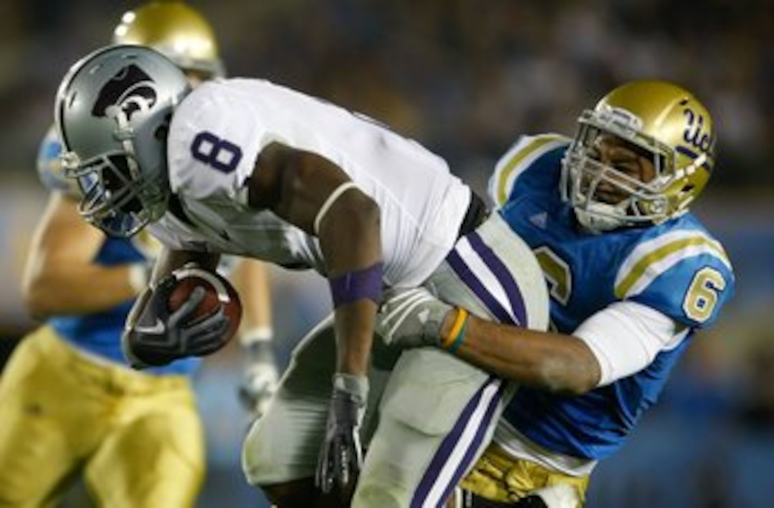 PASADENA, CA - SEPTEMBER 19:  Daniel Thomas #8 of the Kansas State Wildcats is tackled by Tony Dye #6 of the UCLA Bruins in the third quarter at the Rose Bowl on September 19, 2009 in Pasadena, California.  UCLA defeated Kansas State 23-9.  (Photo by Jeff
