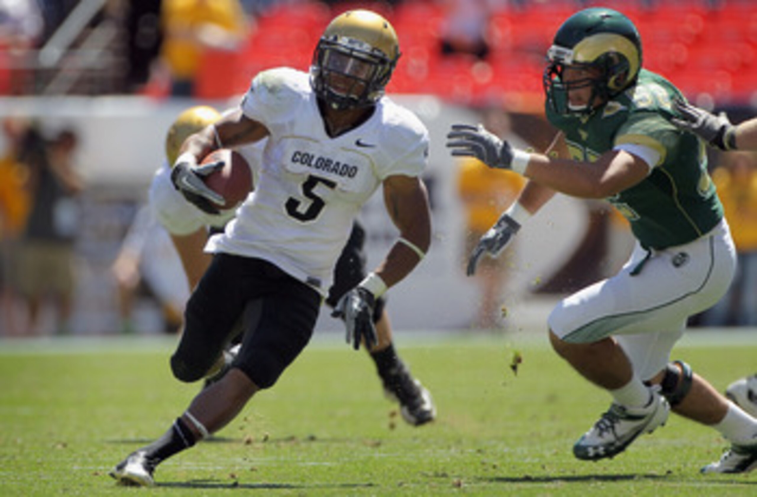 DENVER - SEPTEMBER 04:  Running back Rodney Stewart #5 of the Colorado Buffaloes picks up yardage as he rushes against the Colorado State Rams during the the Rocky Mountain Showdown at INVESCO Field at Mile High on September 4, 2010 in Denver, Colorado.