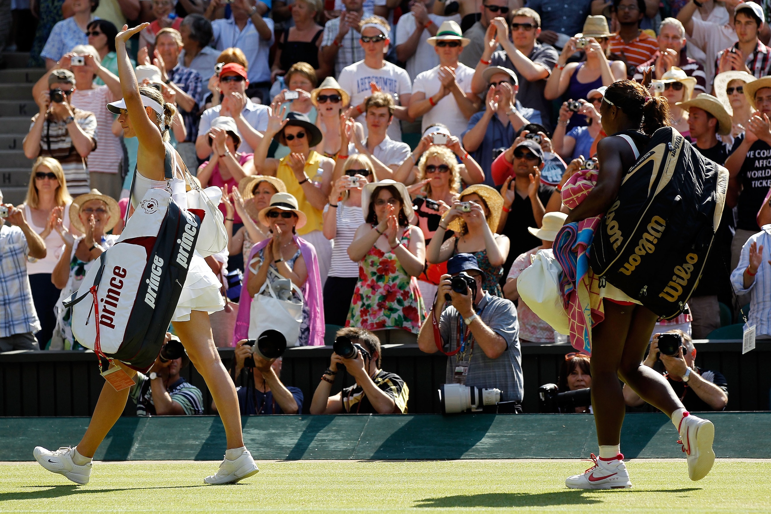 LONDON, ENGLAND - JUNE 28:  Serena Williams of USA (L) exists after winning her match against Maria Sharapova of Russia (R) on Day Seven of the Wimbledon Lawn Tennis Championships at the All England Lawn Tennis and Croquet Club on June 28, 2010 in London,