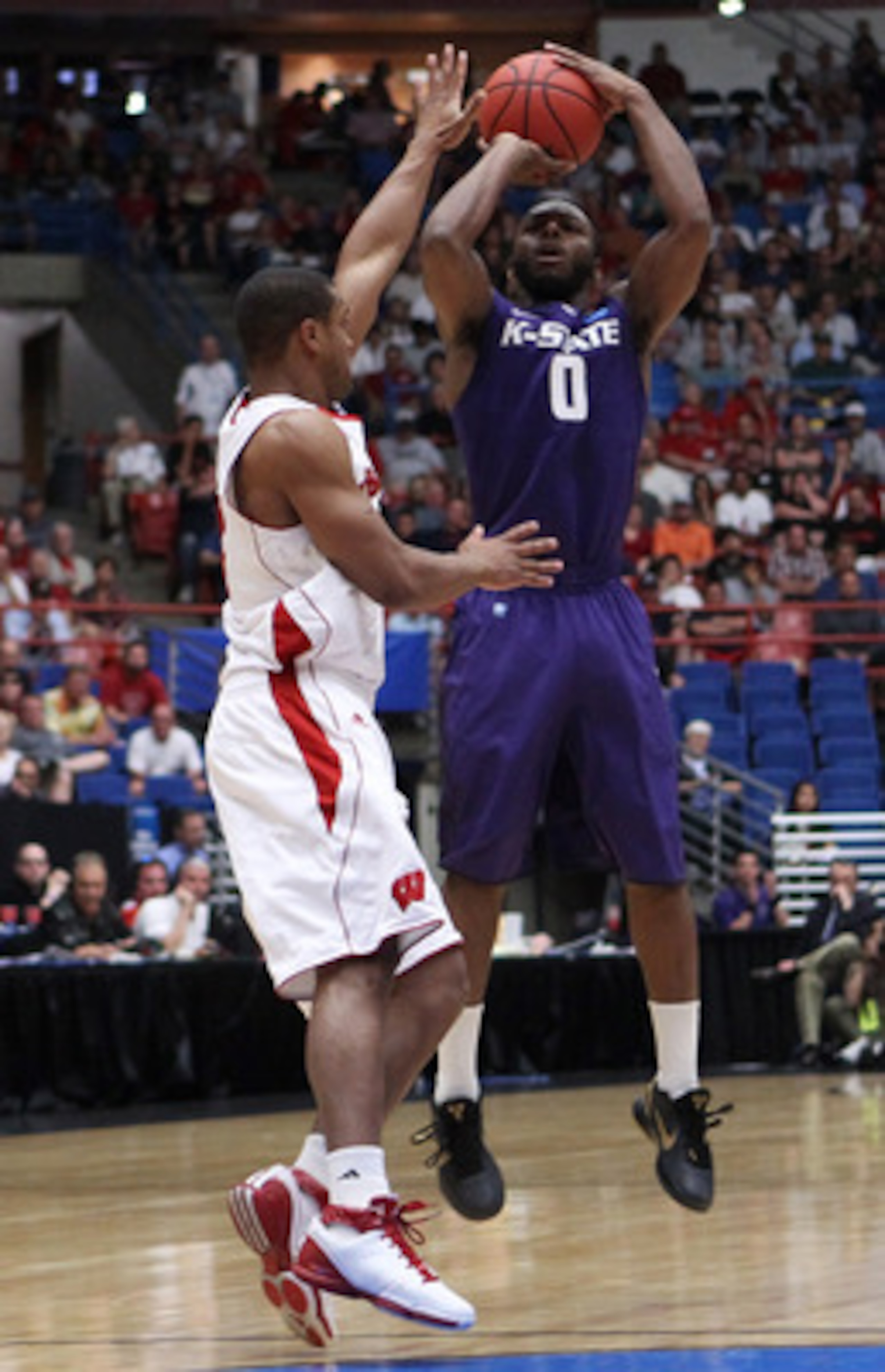TUCSON, AZ - MARCH 19:  Jacob Pullen #0 of the Kansas State Wildcats shoots against the Wisconsin Badgers during the third round of the 2011 NCAA men's basketball tournament at McKale Center on March 19, 2011 in Tucson, Arizona.  (Photo by Christian Peter