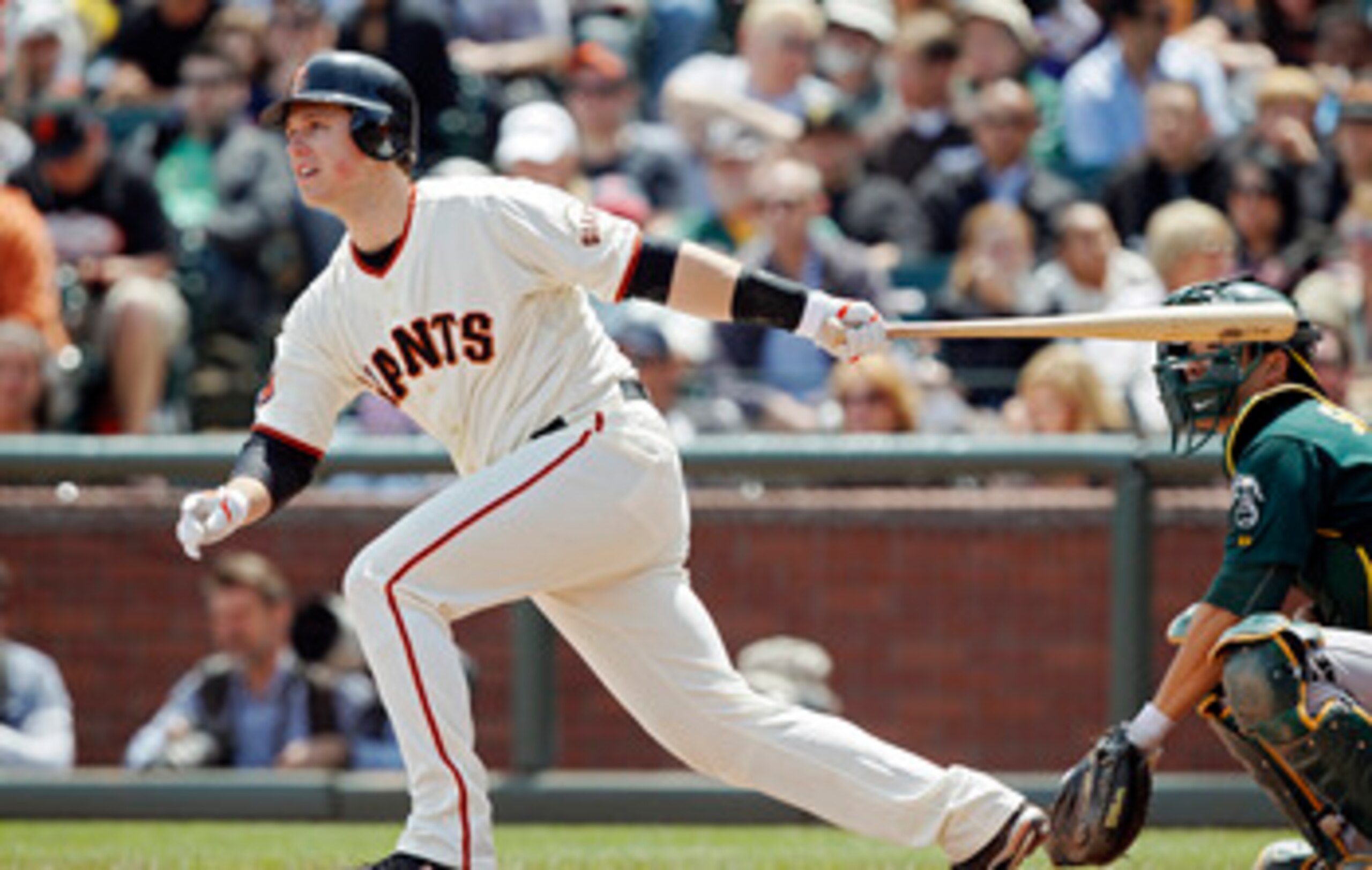 SAN FRANCISCO, CA - MAY 22:  Buster Posey #28 of the San Francisco Giants singles to left field against the Oakland A's  in the third inning at AT&T Park on May 22, 2011 in San Francisco, California.  The Giants won 5-4 in 11 innings.  (Photo by Brian Bah