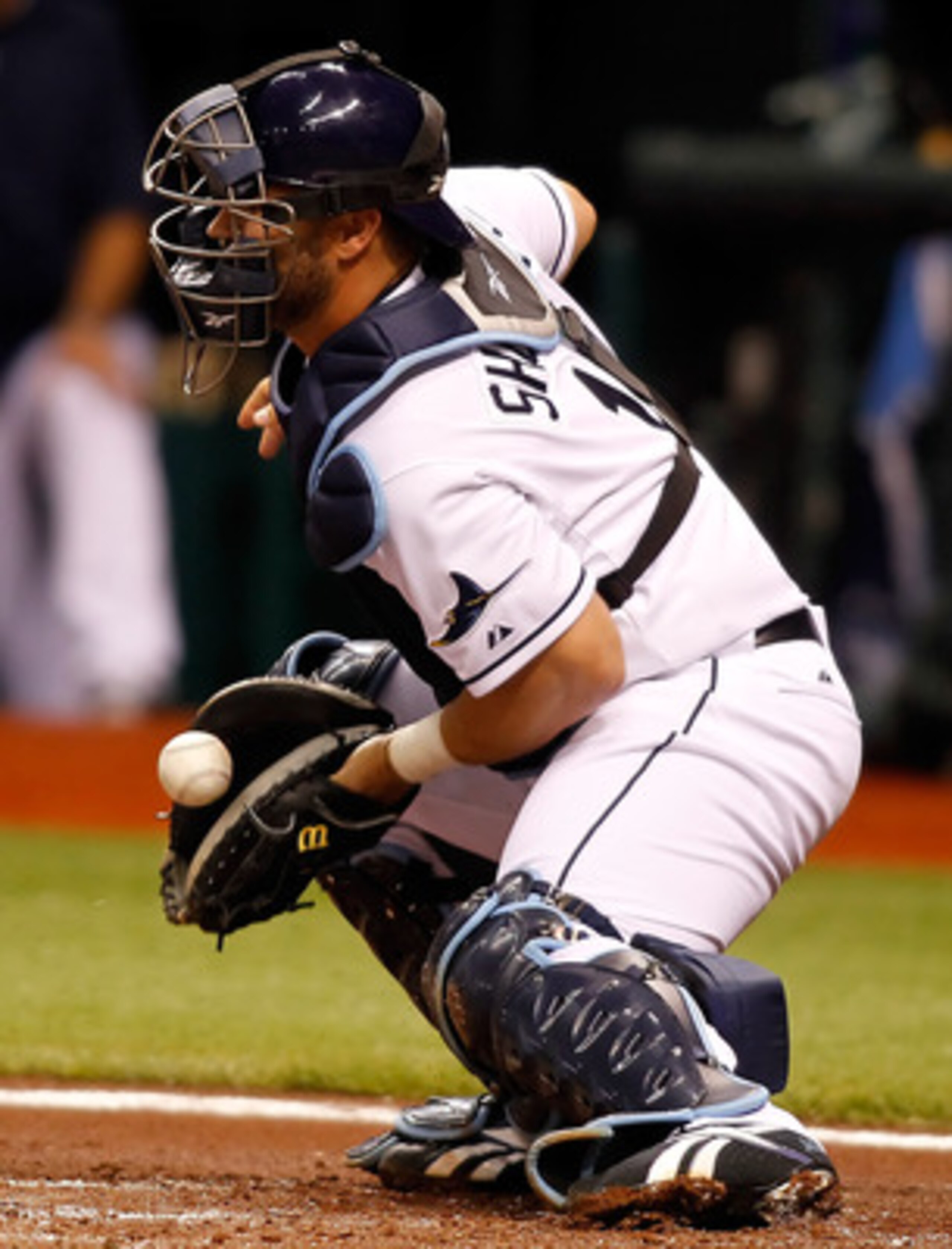 ST. PETERSBURG, FL - APRIL 02:  Catcher Kelly Shoppach #10 of the Tampa Bay Rays makes a stop against the Baltimore Orioles during the game at Tropicana Field on April 2, 2011 in St. Petersburg, Florida.  (Photo by J. Meric/Getty Images)