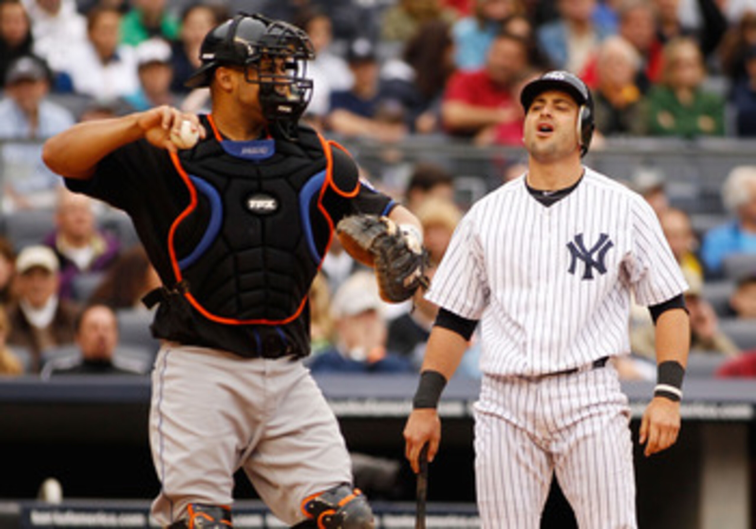 NEW YORK - MAY 22:  Francisco Cervelli #17 of the New York Yankees reacts after striking out with a man on second and nobody out as Ronny Paulino #9 of the New York Mets throws to third on May 22, 2011 at Yankee Stadium in the Bronx borough of New York Ci