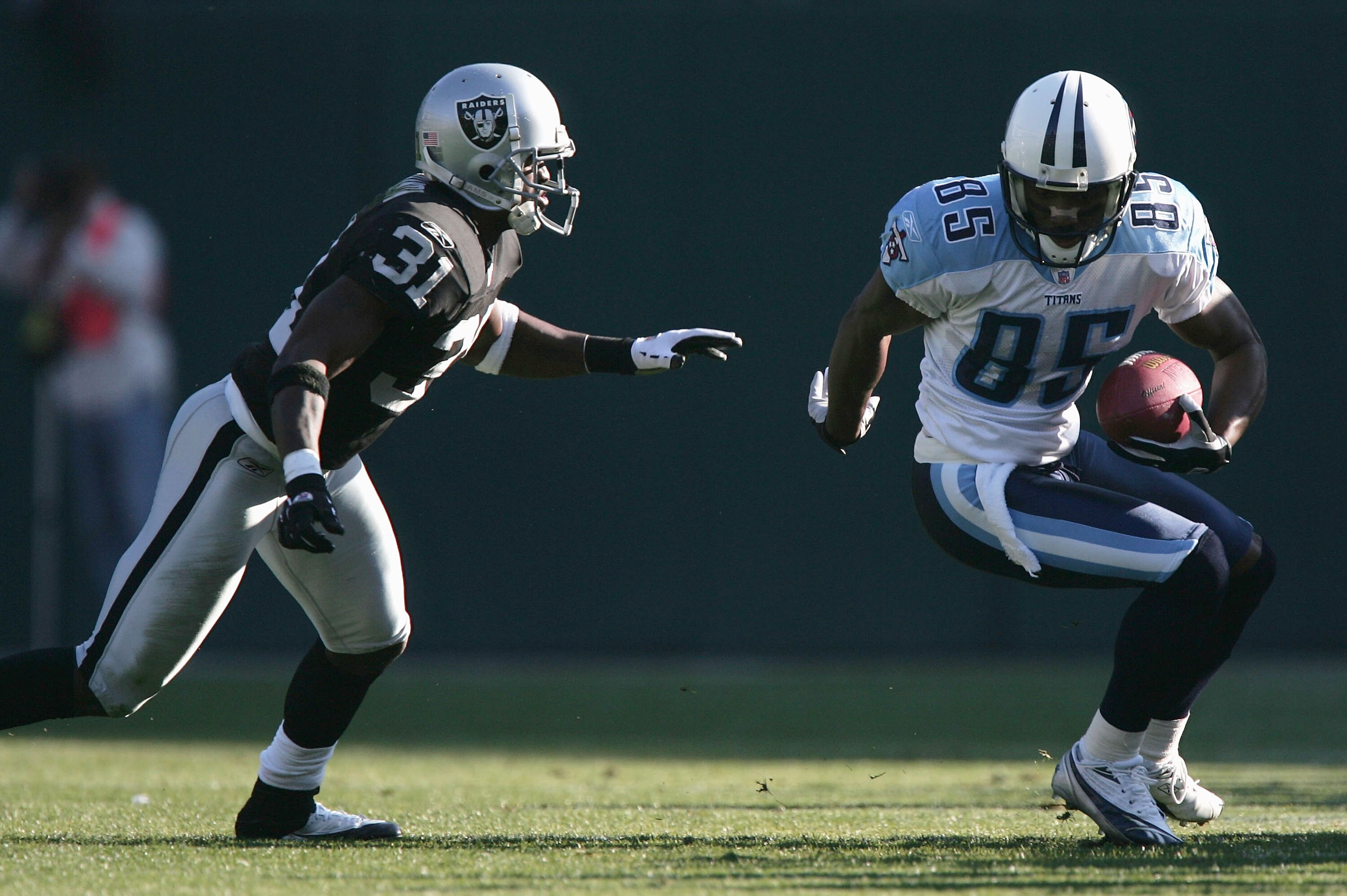 OAKLAND, CA - DECEMBER 19: Wide receiver Derrick Mason #85 of the Tennessee Titans runs with the ball after a reception against cornerback Phillip Buchanon #31 of the Oakland Raiders in the second quarter at Network Associates Coliseum on December 19, 20 OAKLAND, CA - DECEMBER 19: Wide receiver Derrick Mason #85 of the Tennessee Titans runs with the ball after a reception against cornerback Phillip Buchanon #31 of the Oakland Raiders in the second quarter at Network Associates Coliseum on December 19, 20